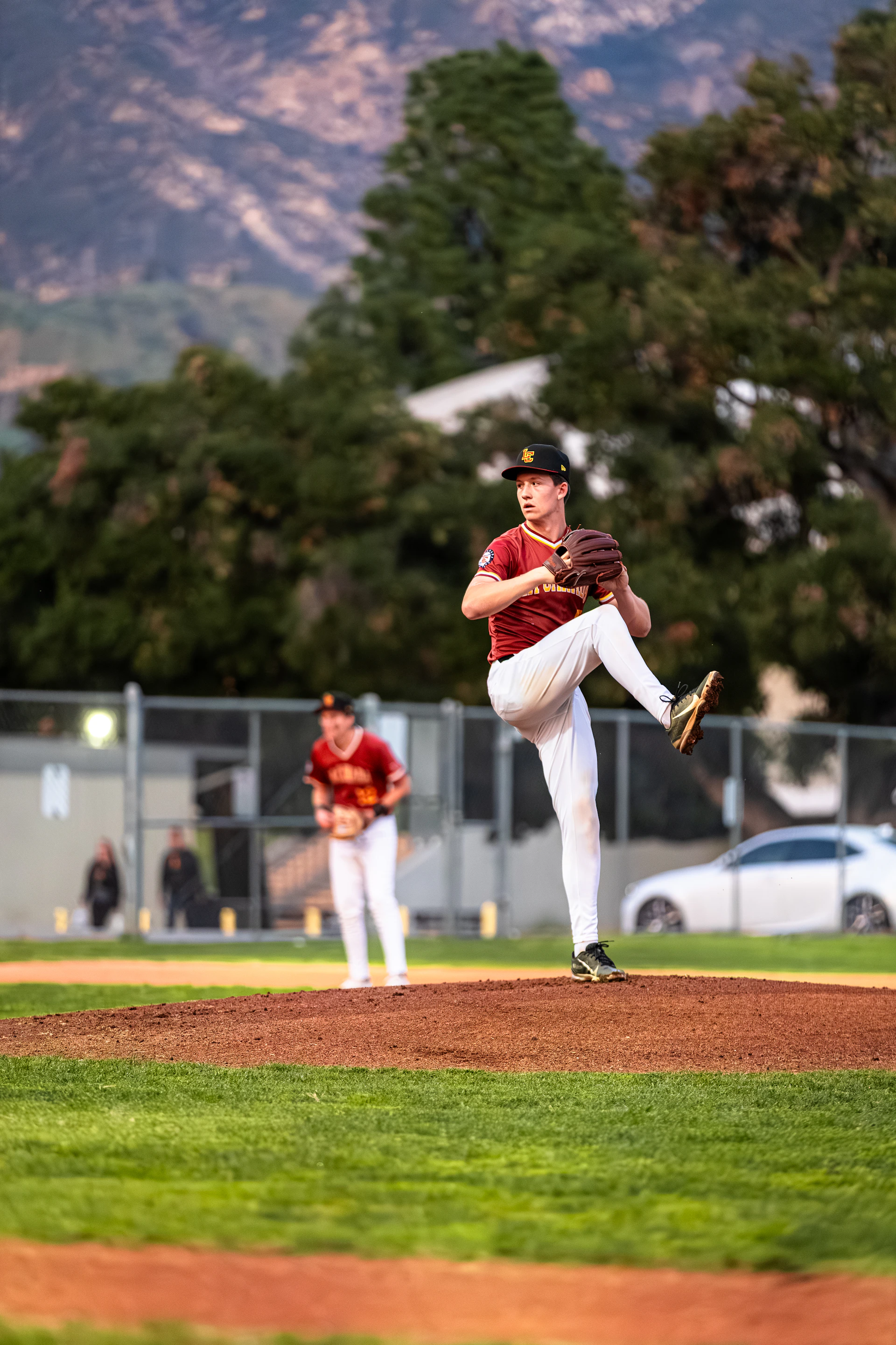 Baseball pitcher in uniform on the mound ready to throw.