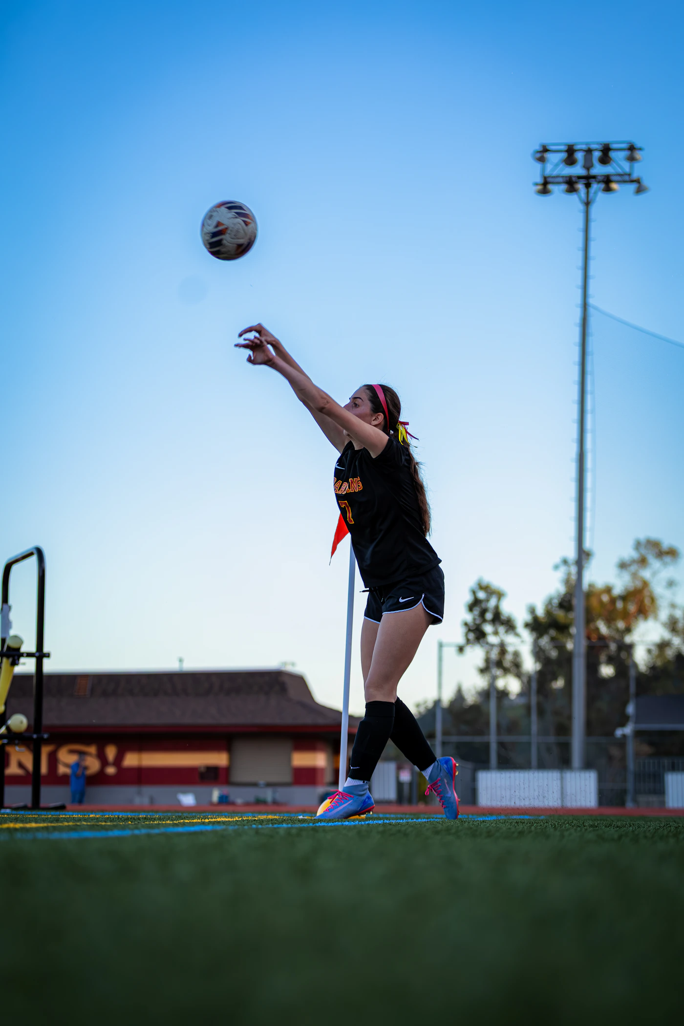 athlete on a field at golden hour, mid action.