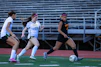 Young women playing soccer on a field