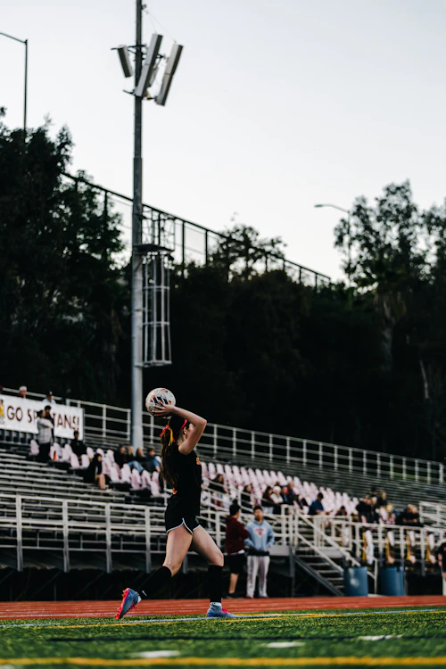 Player serving the ball on a field
