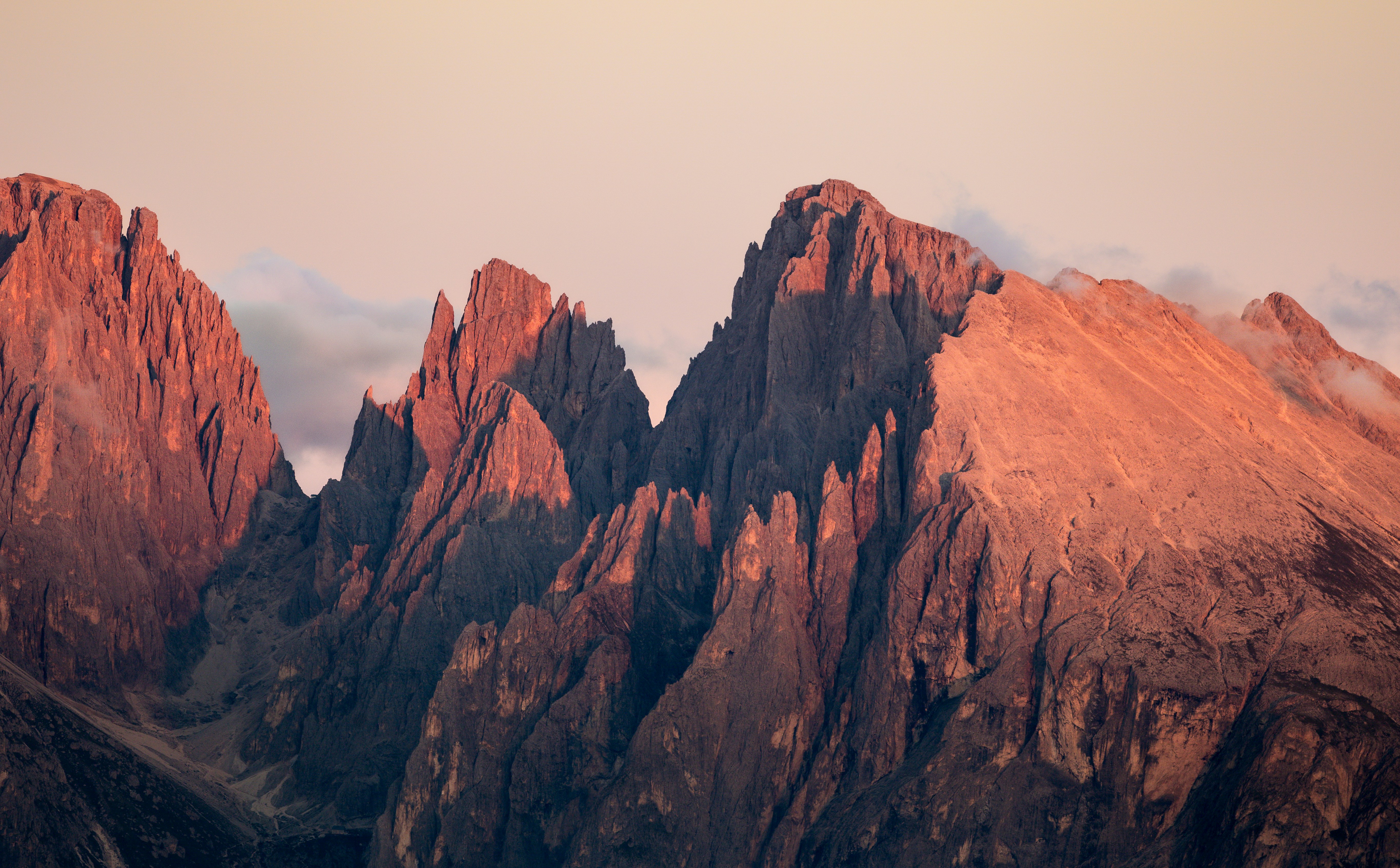 Jagged mountain peaks bathed in warm sunset light.
