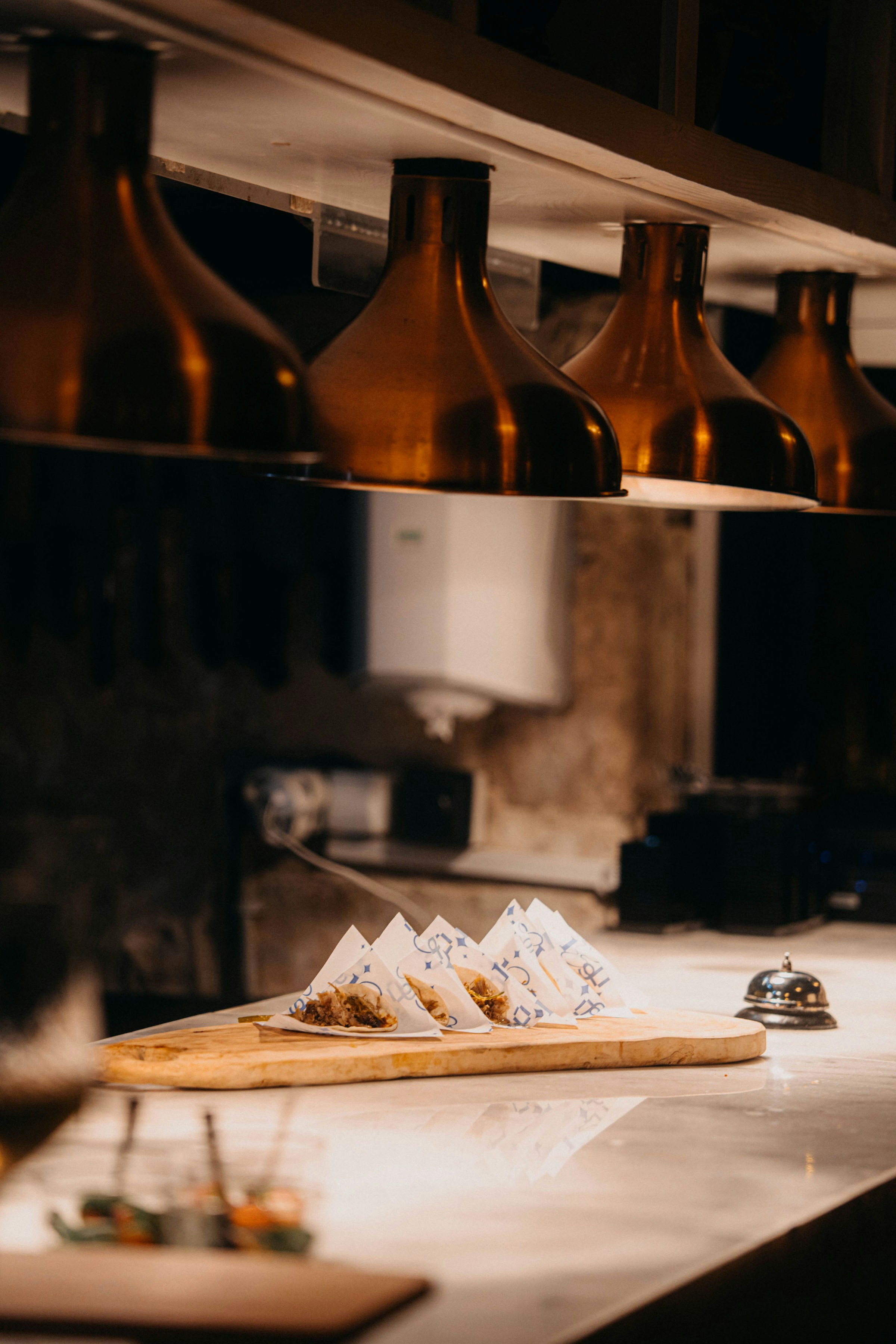 Vorspeisen, serviert auf einem Holzbrett unter Restaurantlichtern.