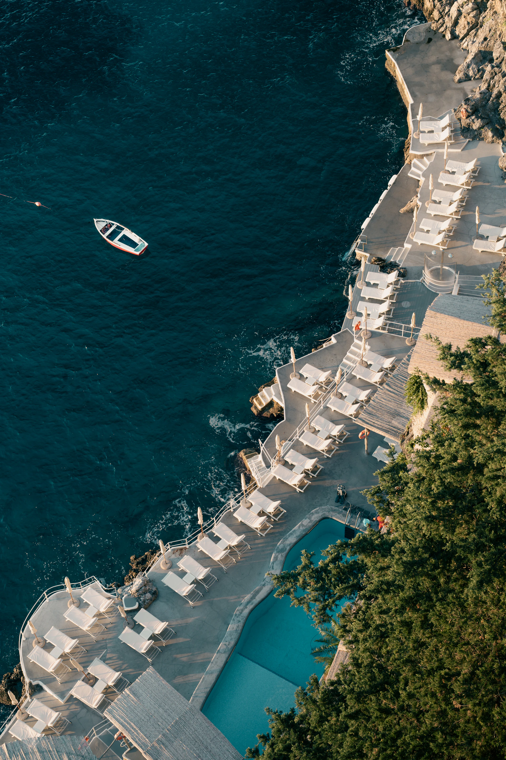 Resort with pool and lounge chairs by the ocean