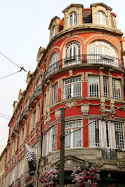 Ornate red building with balconies and windows.