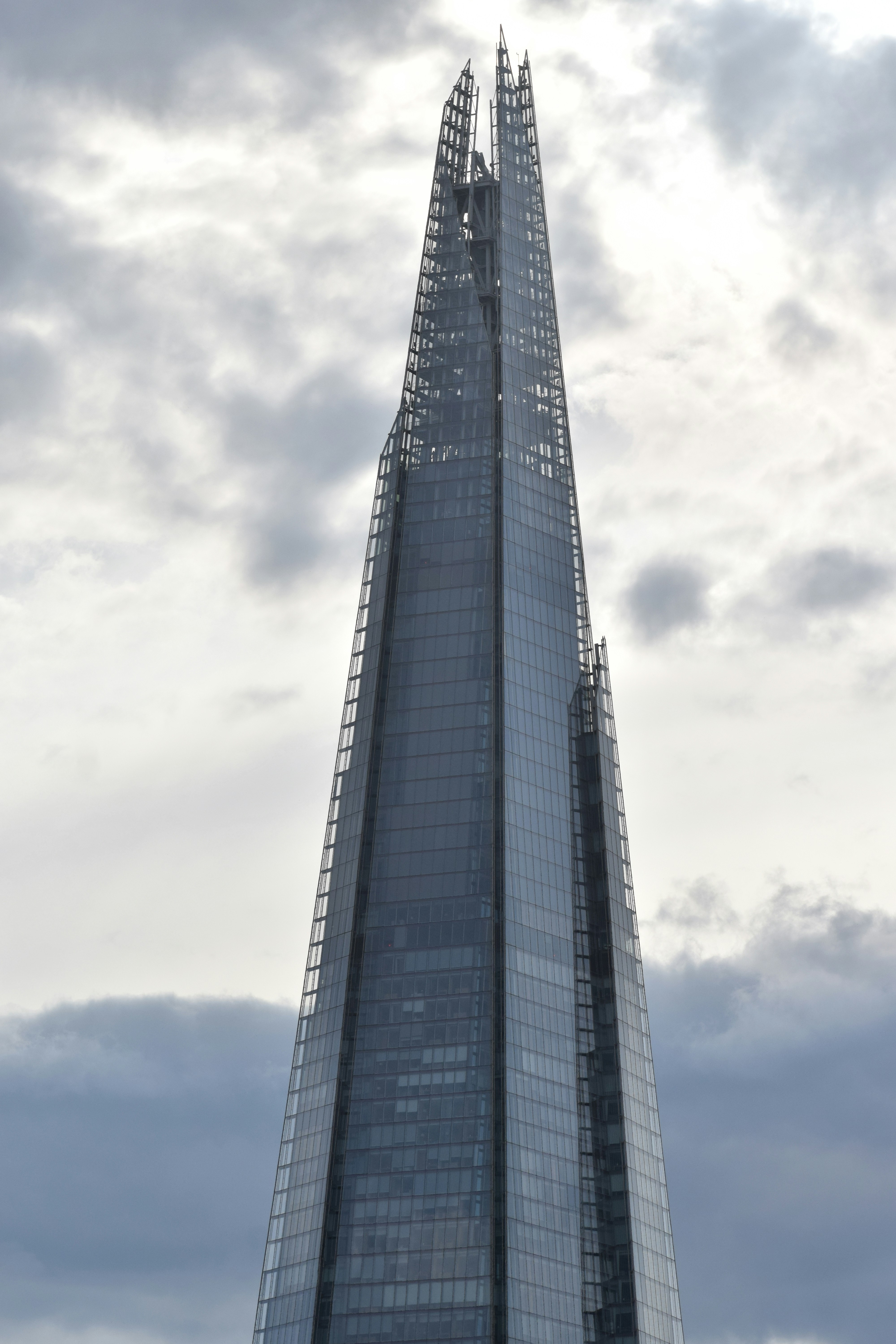 Modern skyscraper against a cloudy sky