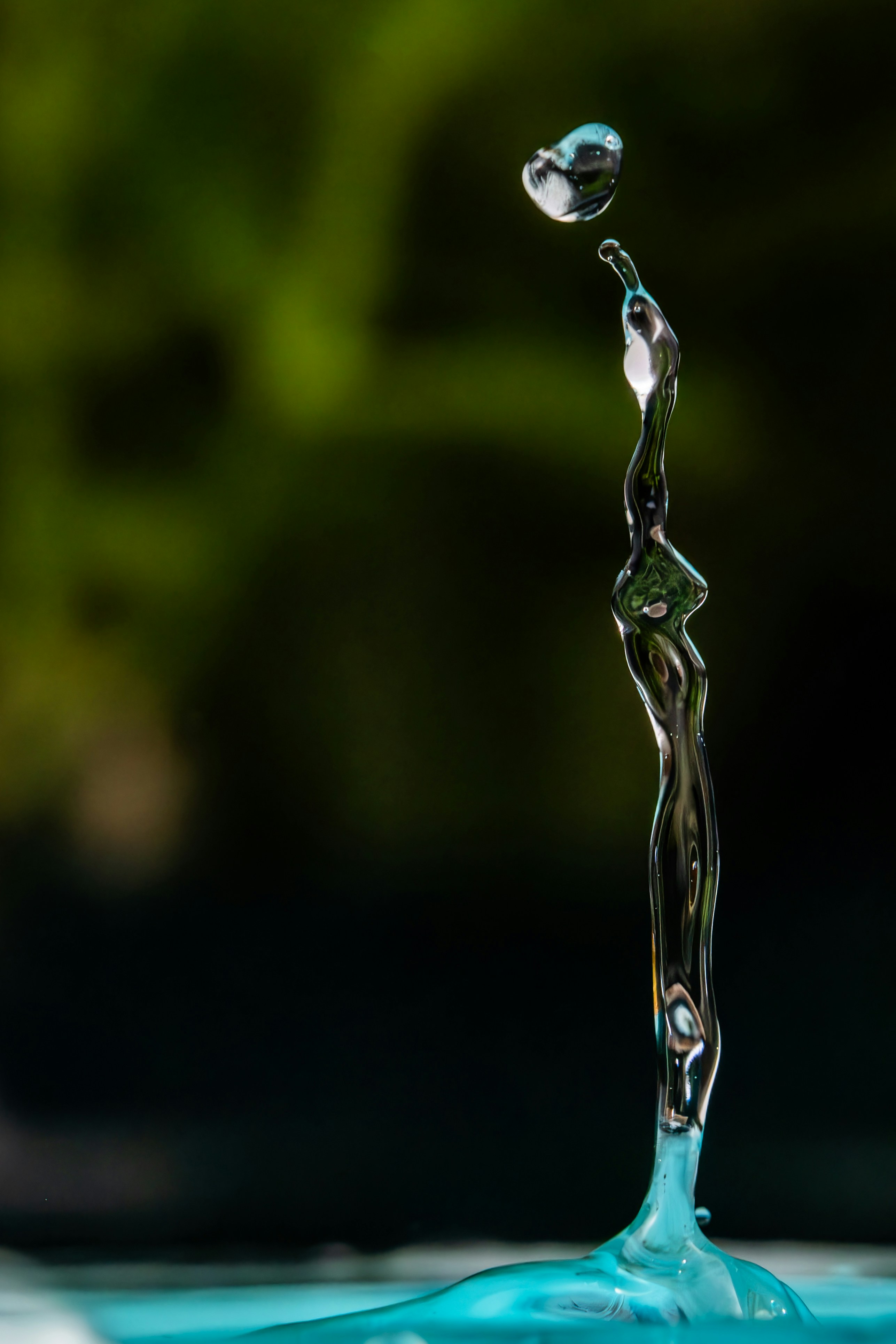 Water droplet sculpture with blurred green background