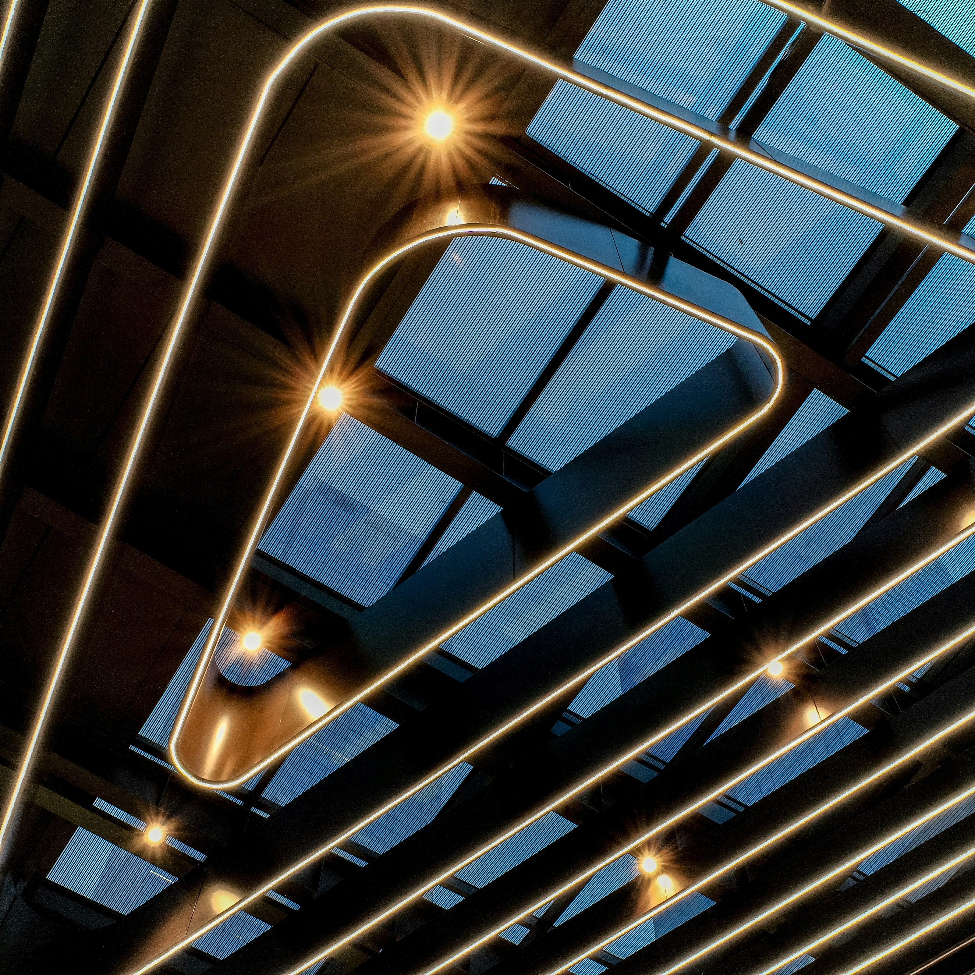 Modern ceiling with geometric lighting and skylights
