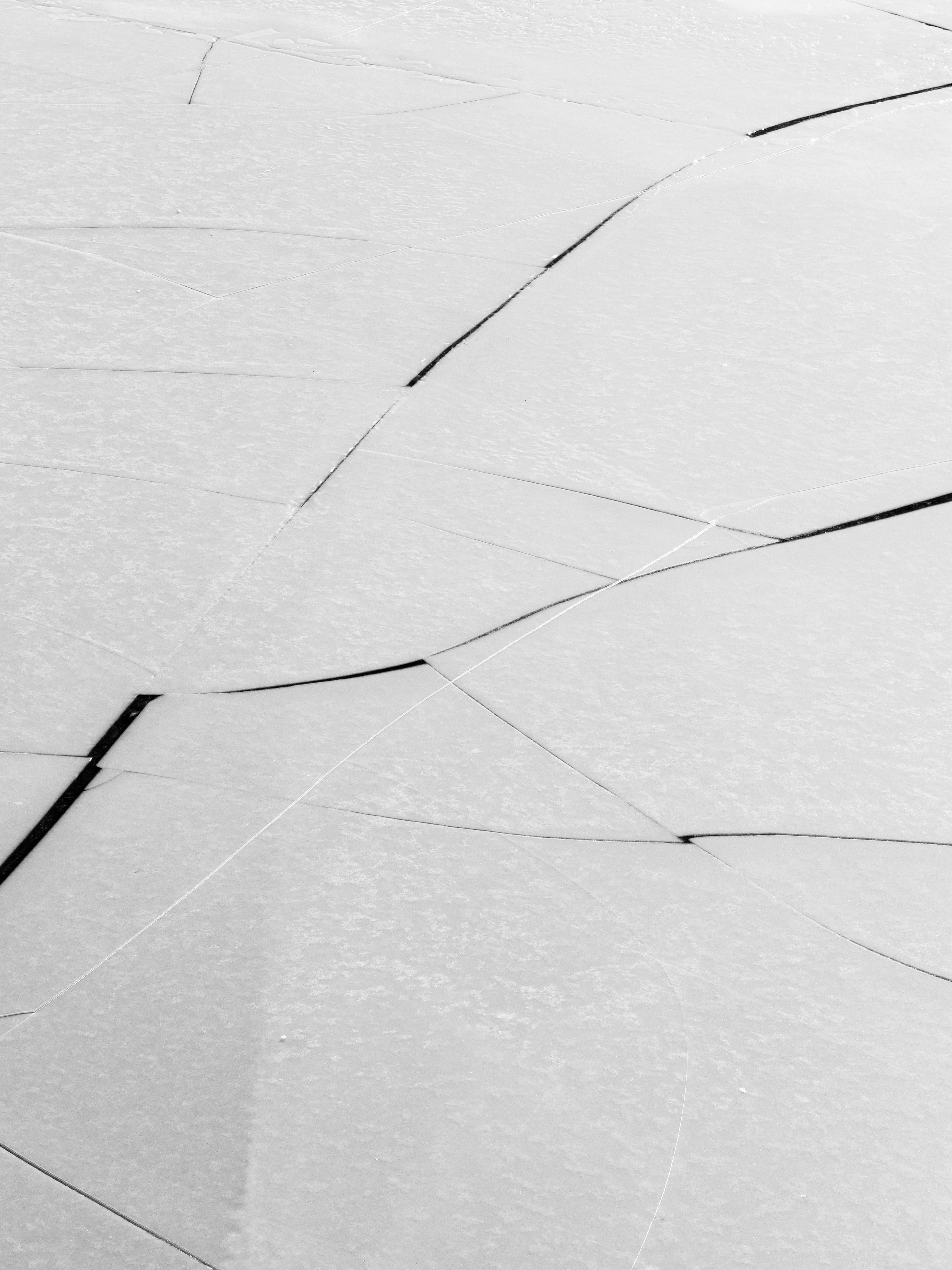 Cracked white surface with dark lines