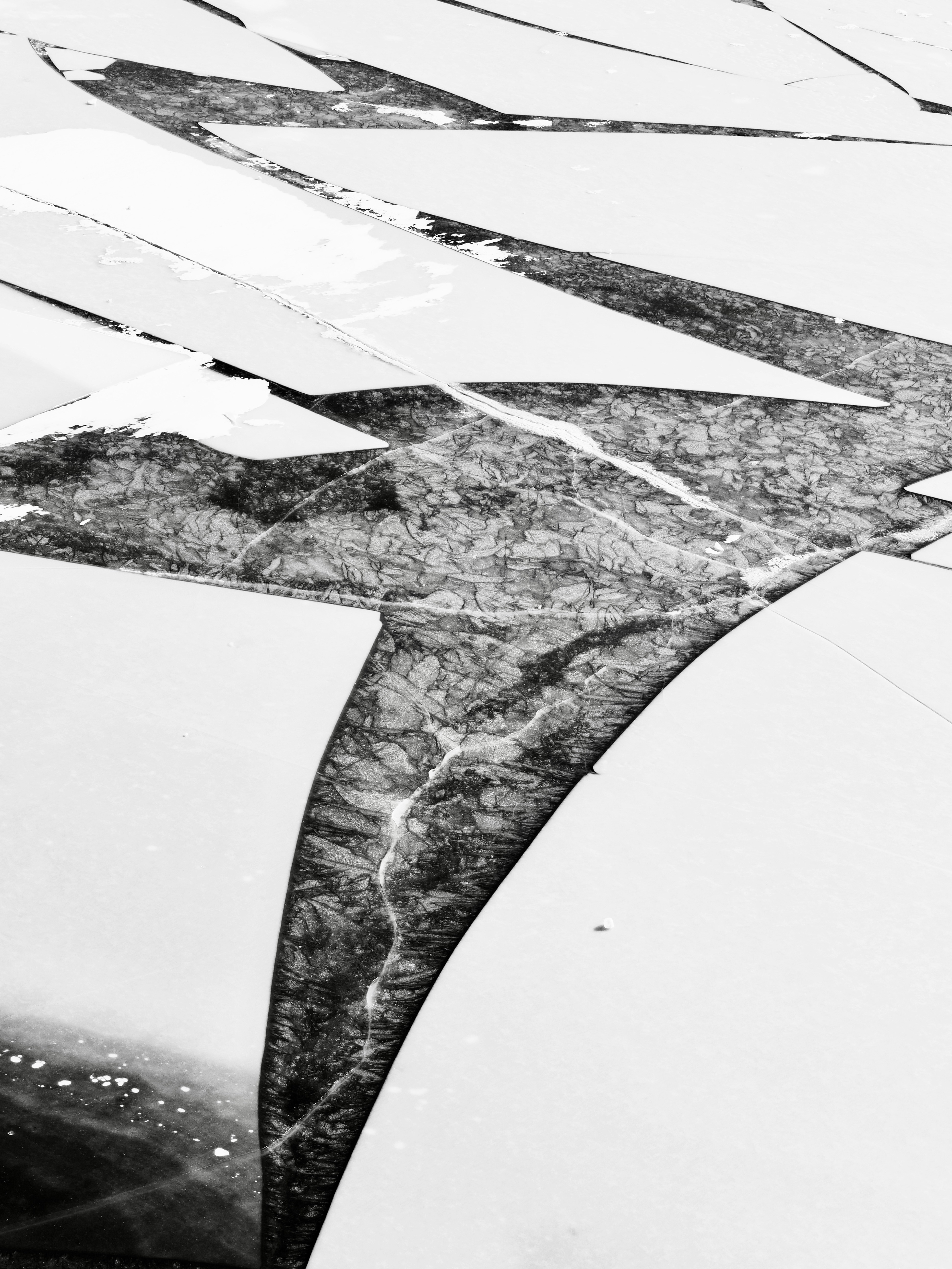 Cracked ice patterns on a frozen body of water