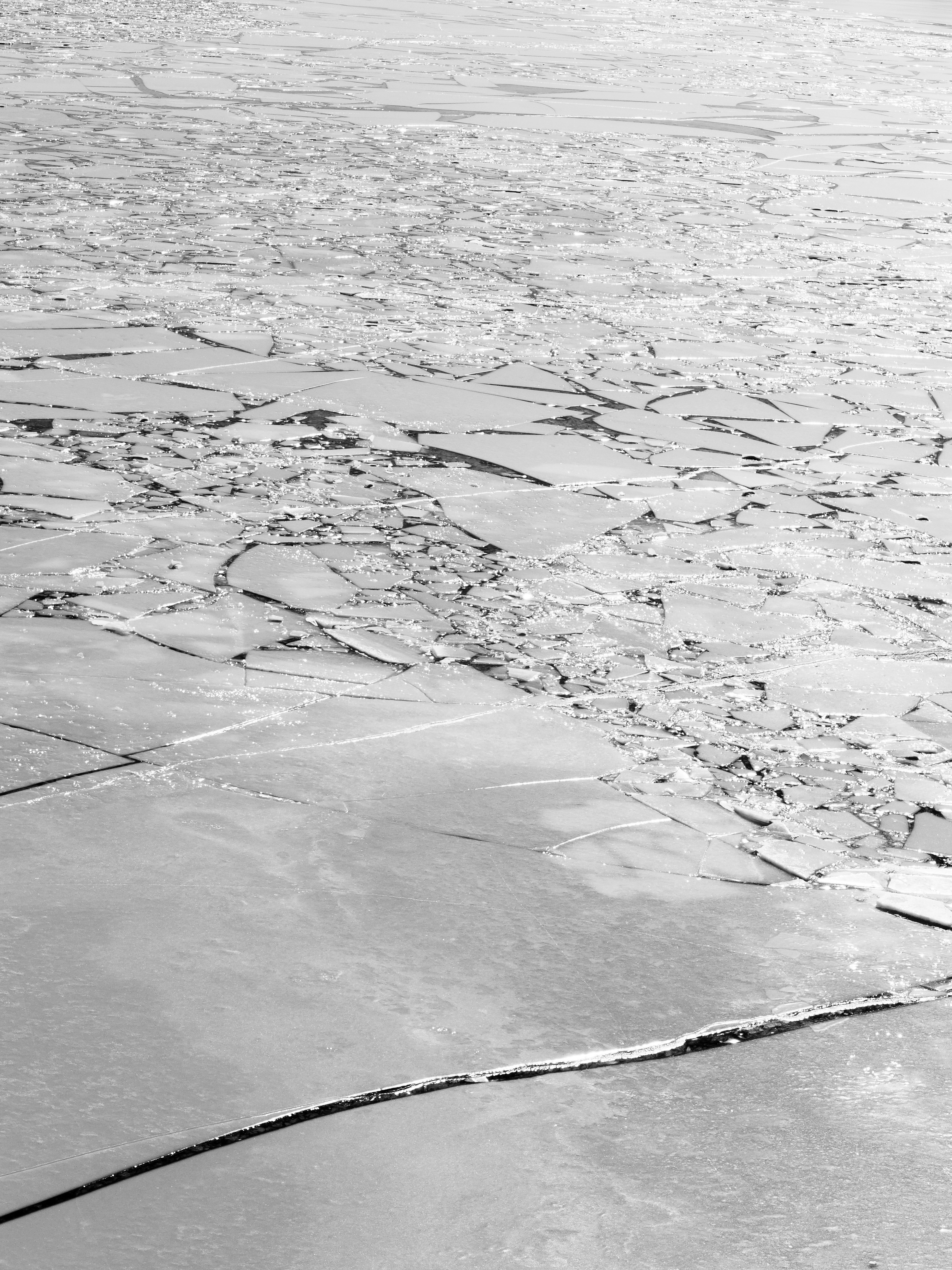 Cracked ice surface with visible lines and textures.