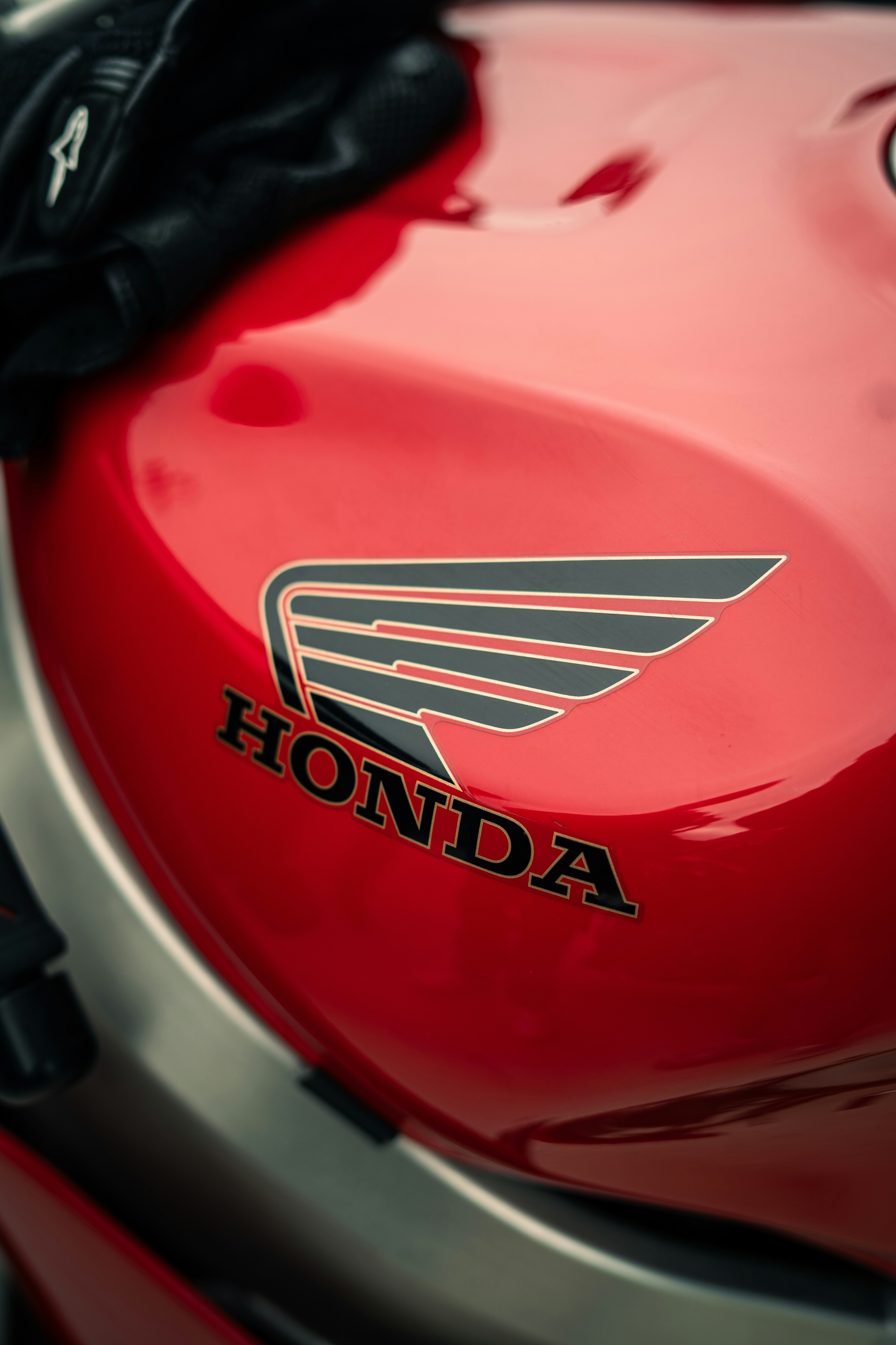 Close-up of a red honda motorcycle fuel tank logo