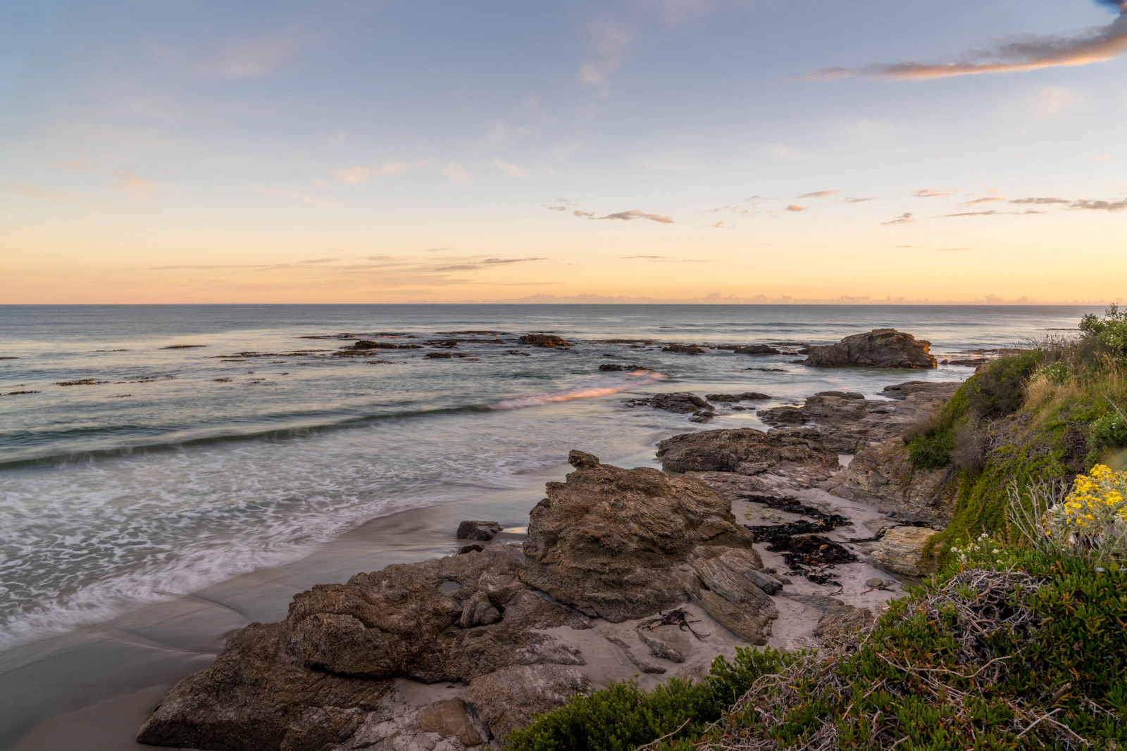 A rocky coastline at sunset, Brighton Beach, Otago
