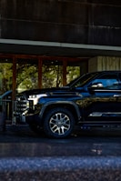 Black pickup truck parked outside modern building