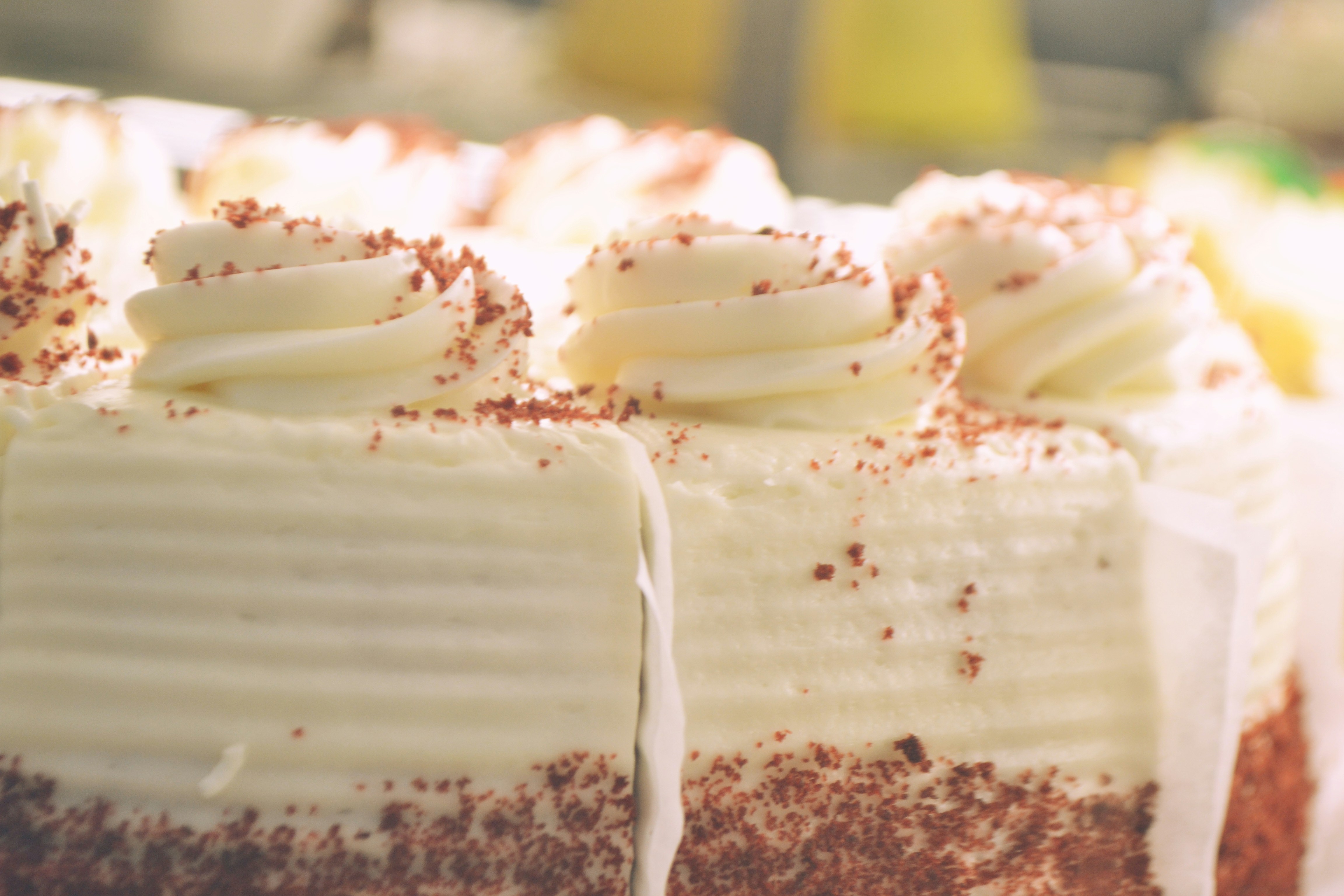 Close-up of a frosted cake with chocolate shavings.