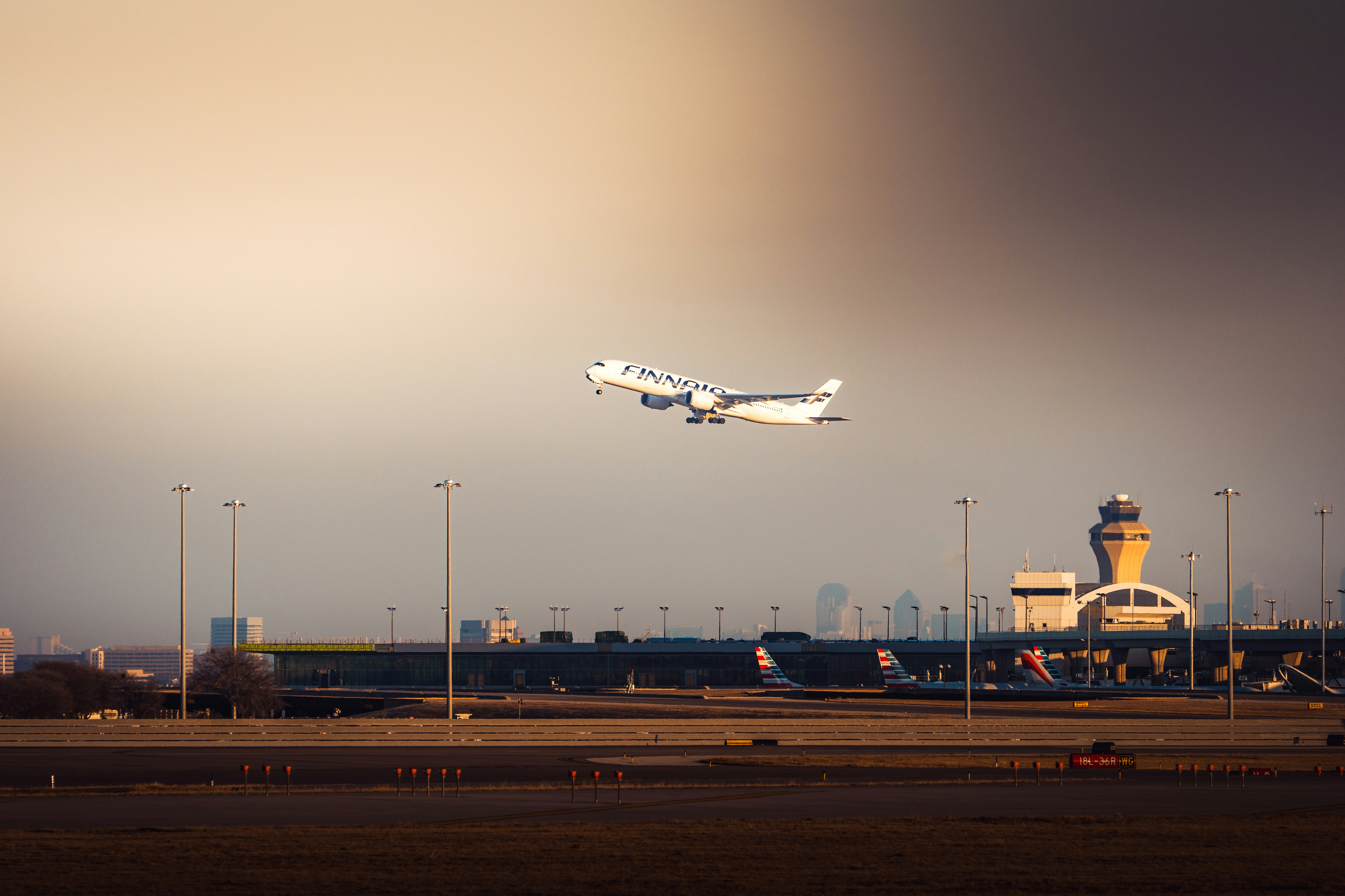 Airplane taking off from airport with control tower