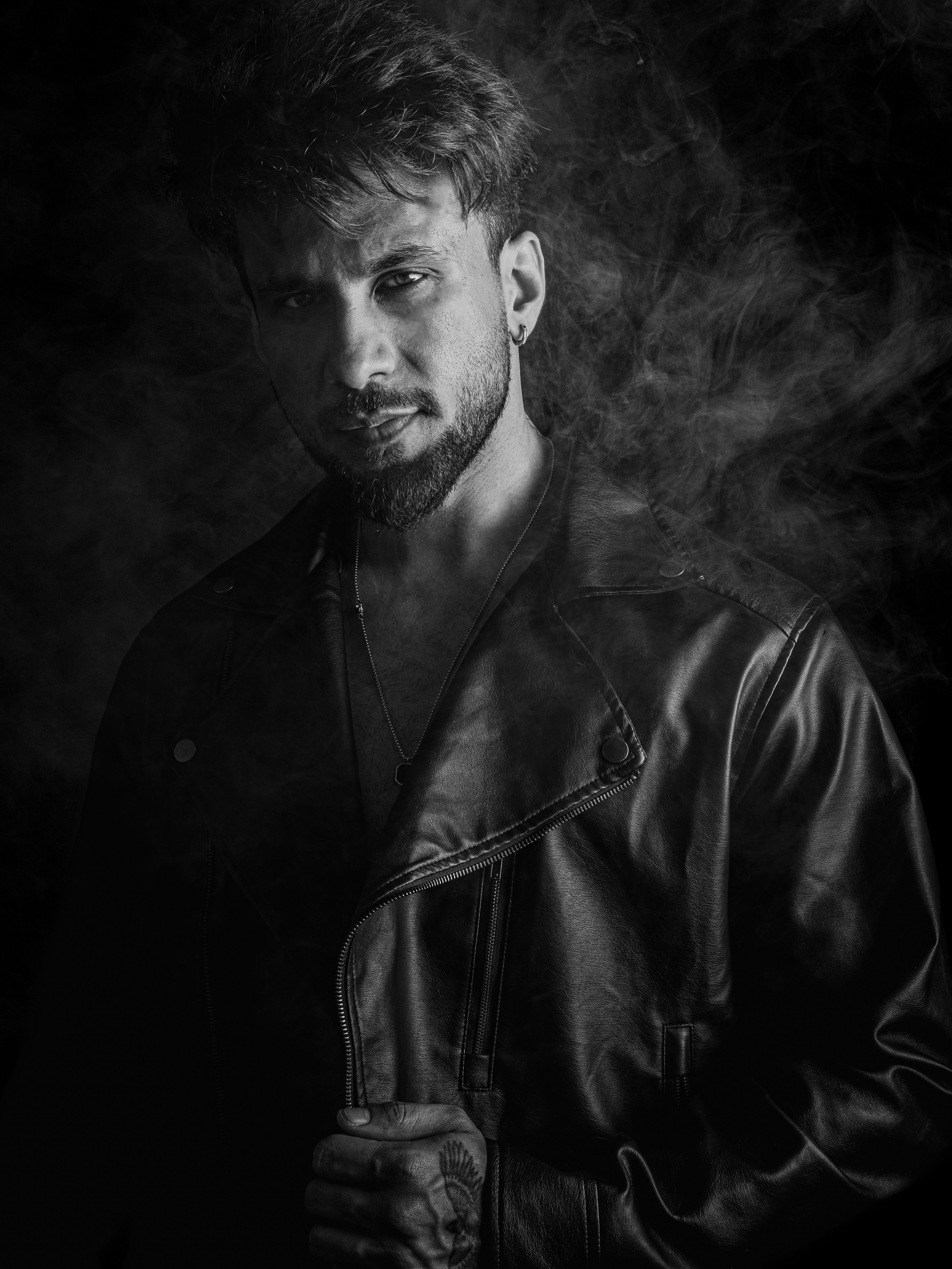 Man in leather jacket with smoke