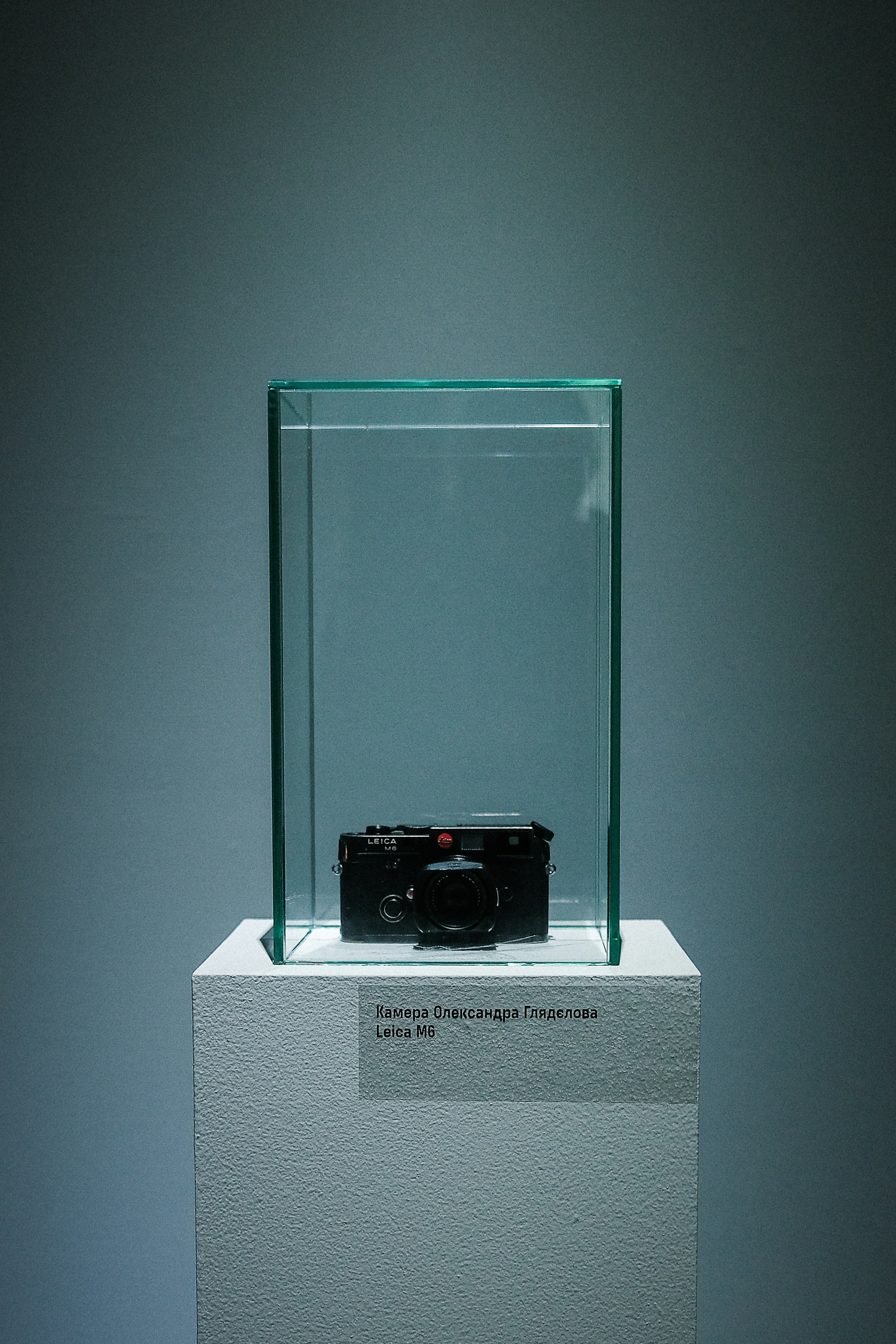 A vintage camera displayed in a glass case.