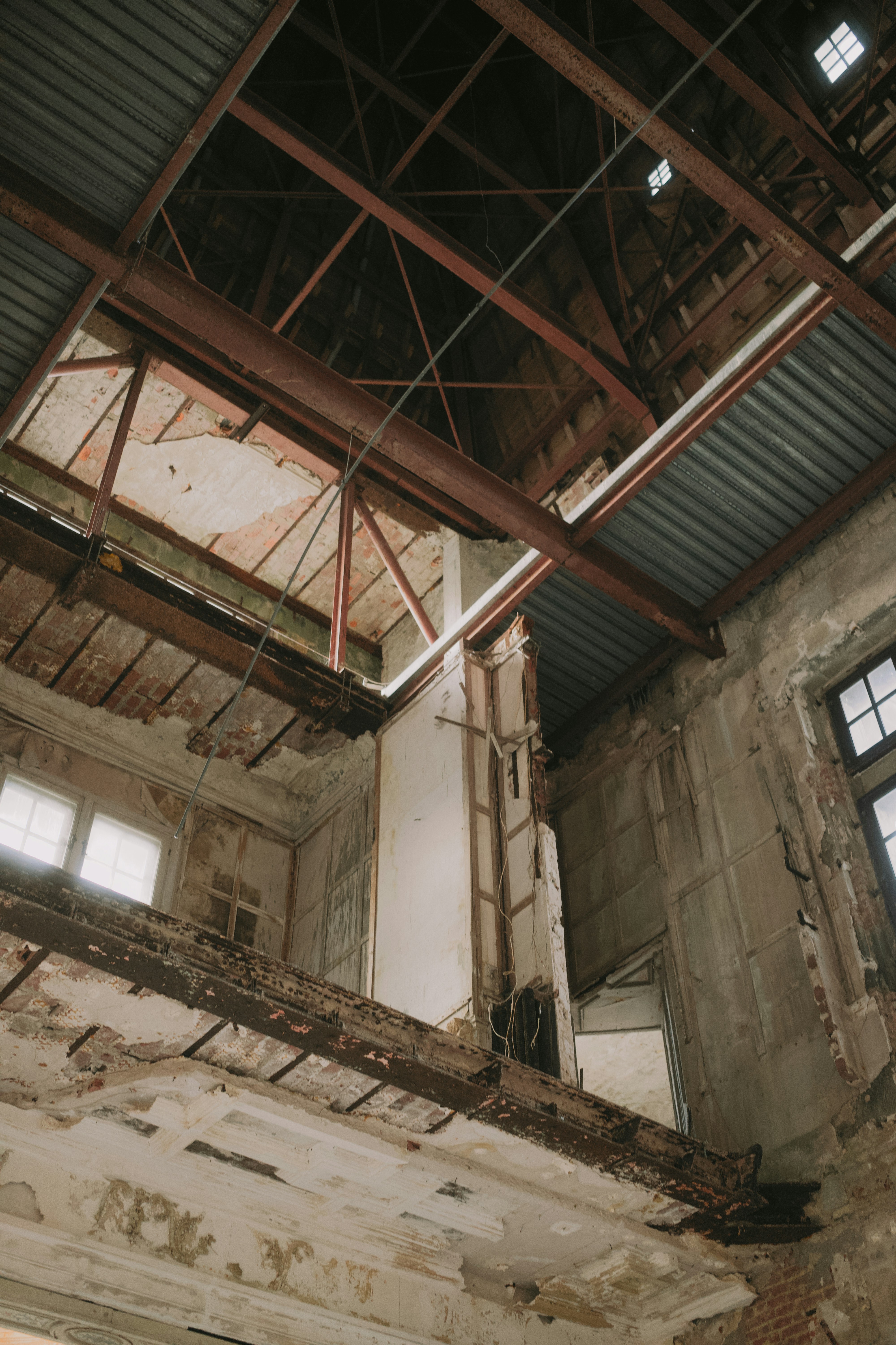 Interior of a dilapidated building with exposed beams.