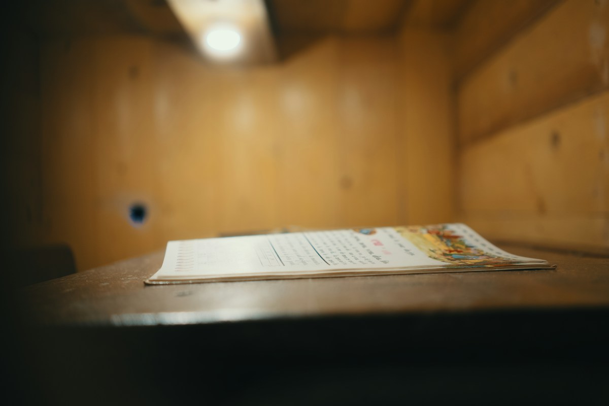 A holiday food drive sign-up sheet on a wooden table, ready for group service project planning and coordination.
