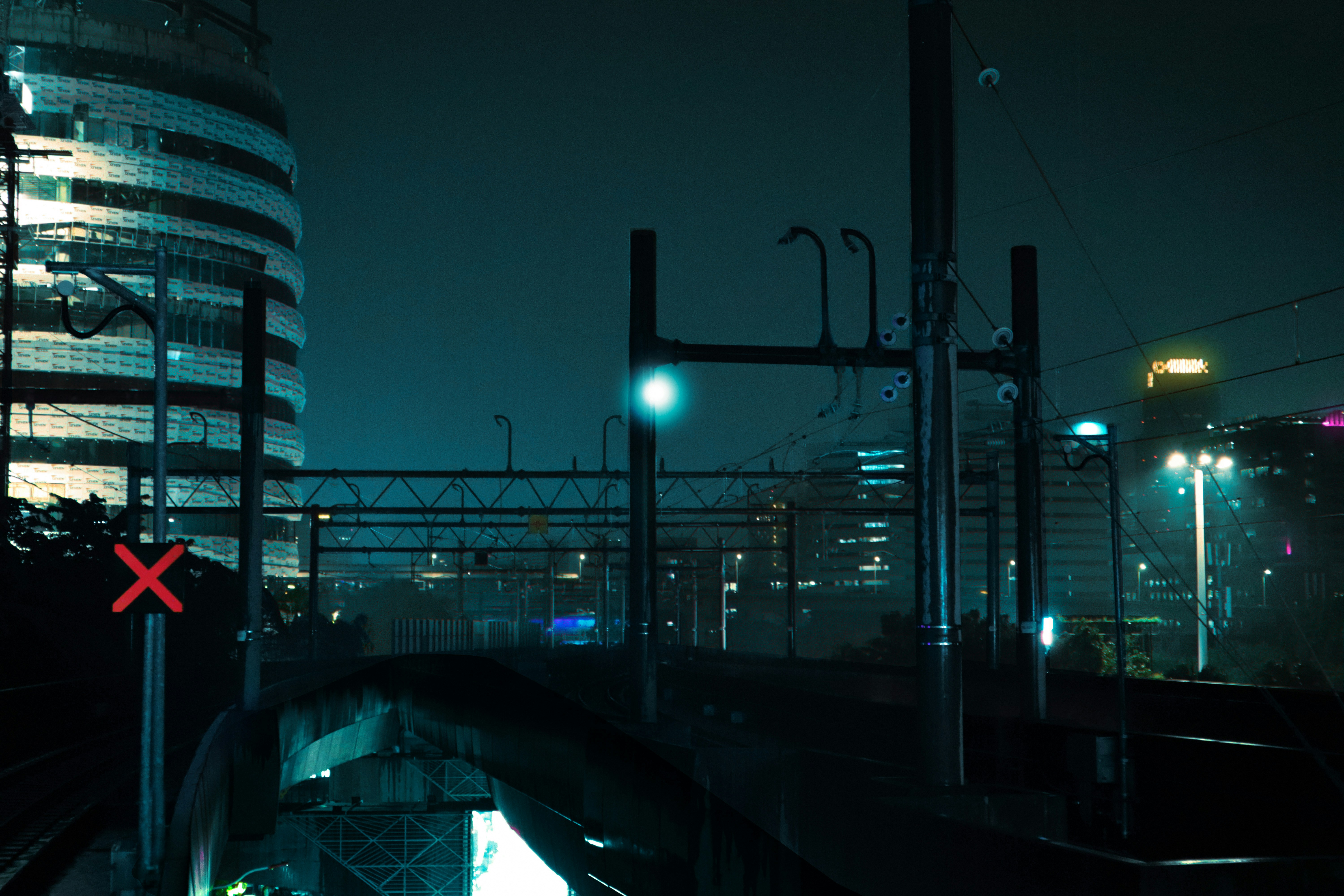 Cityscape at night with train tracks and lights
