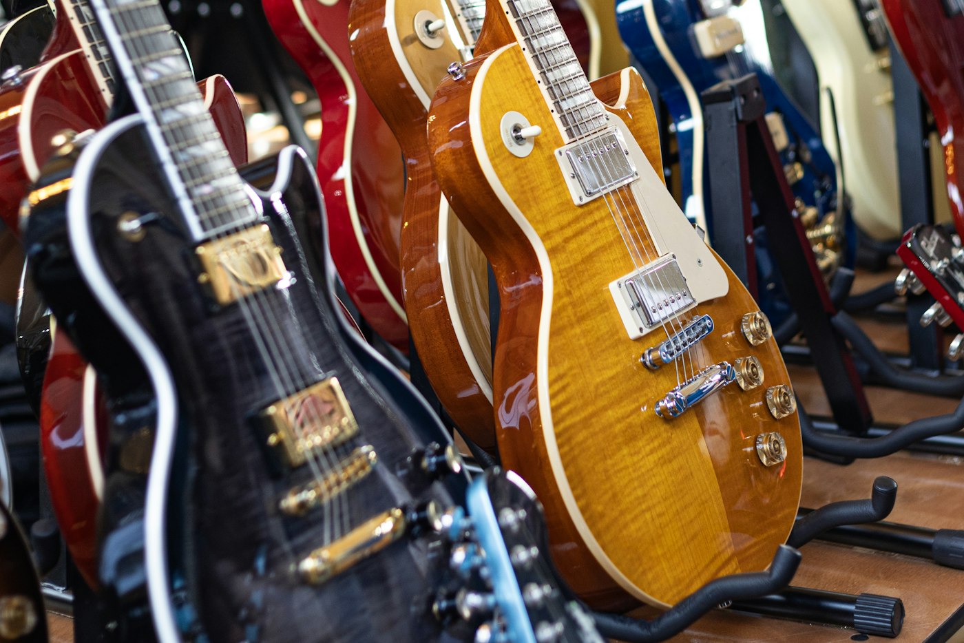 Black, amber, and red electric guitars standing in a display row