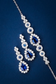 Sparkling blue gemstone jewelry set on dark blue background