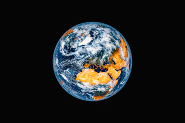 Planet earth seen from space with clouds and landmasses.