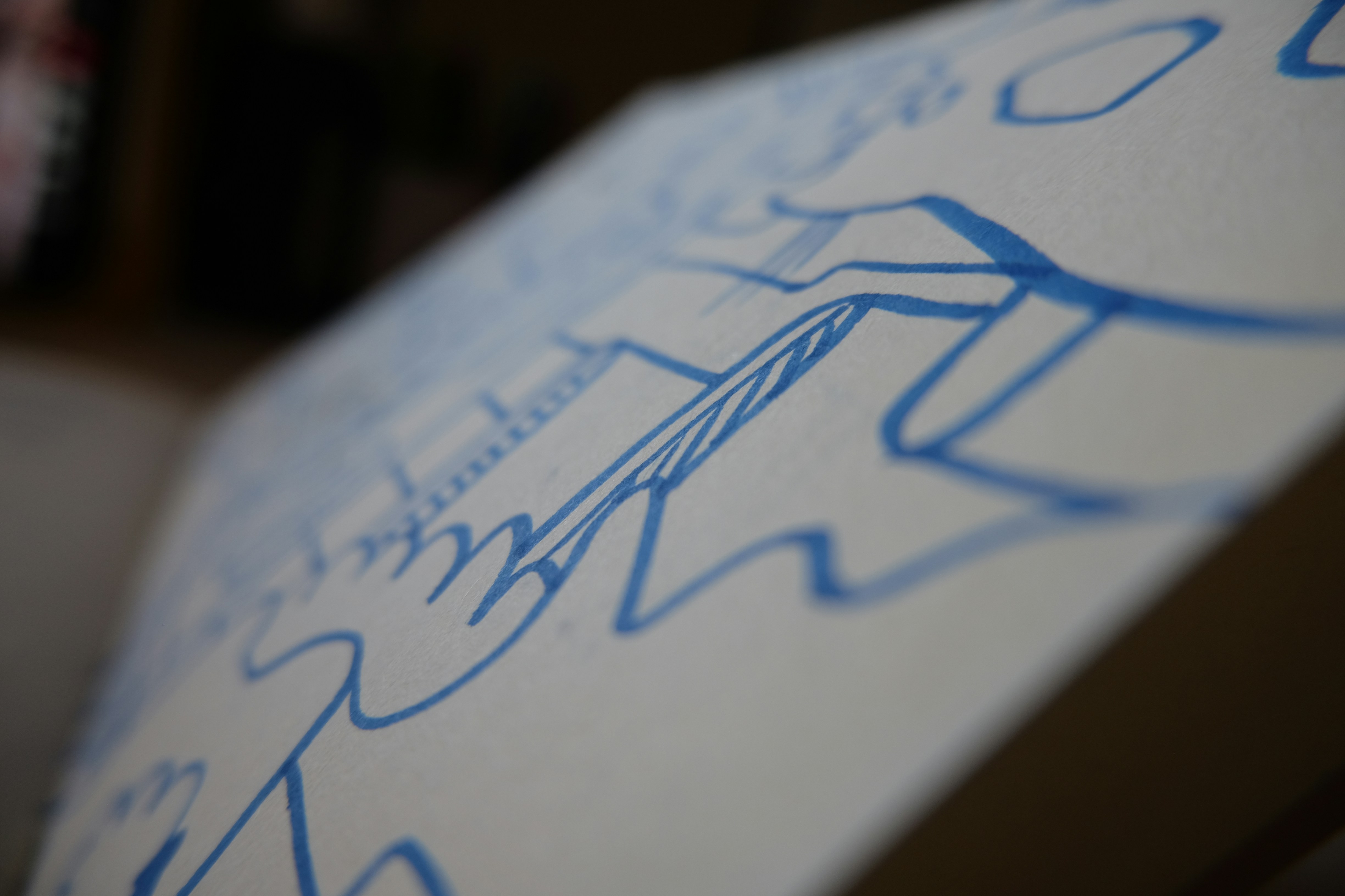 Blue abstract drawing on a white canvas