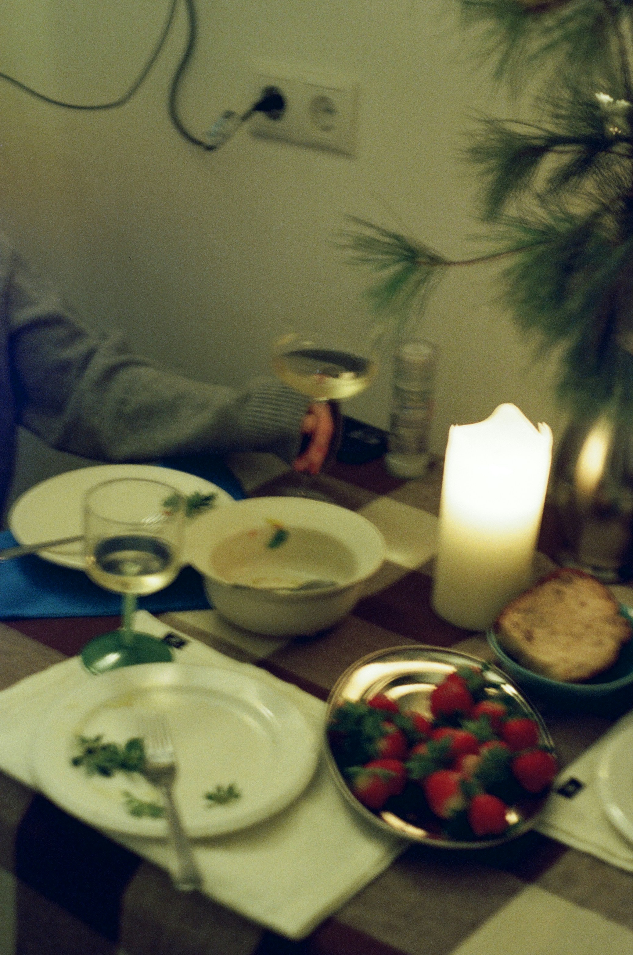 A table set for a meal with strawberries and wine.