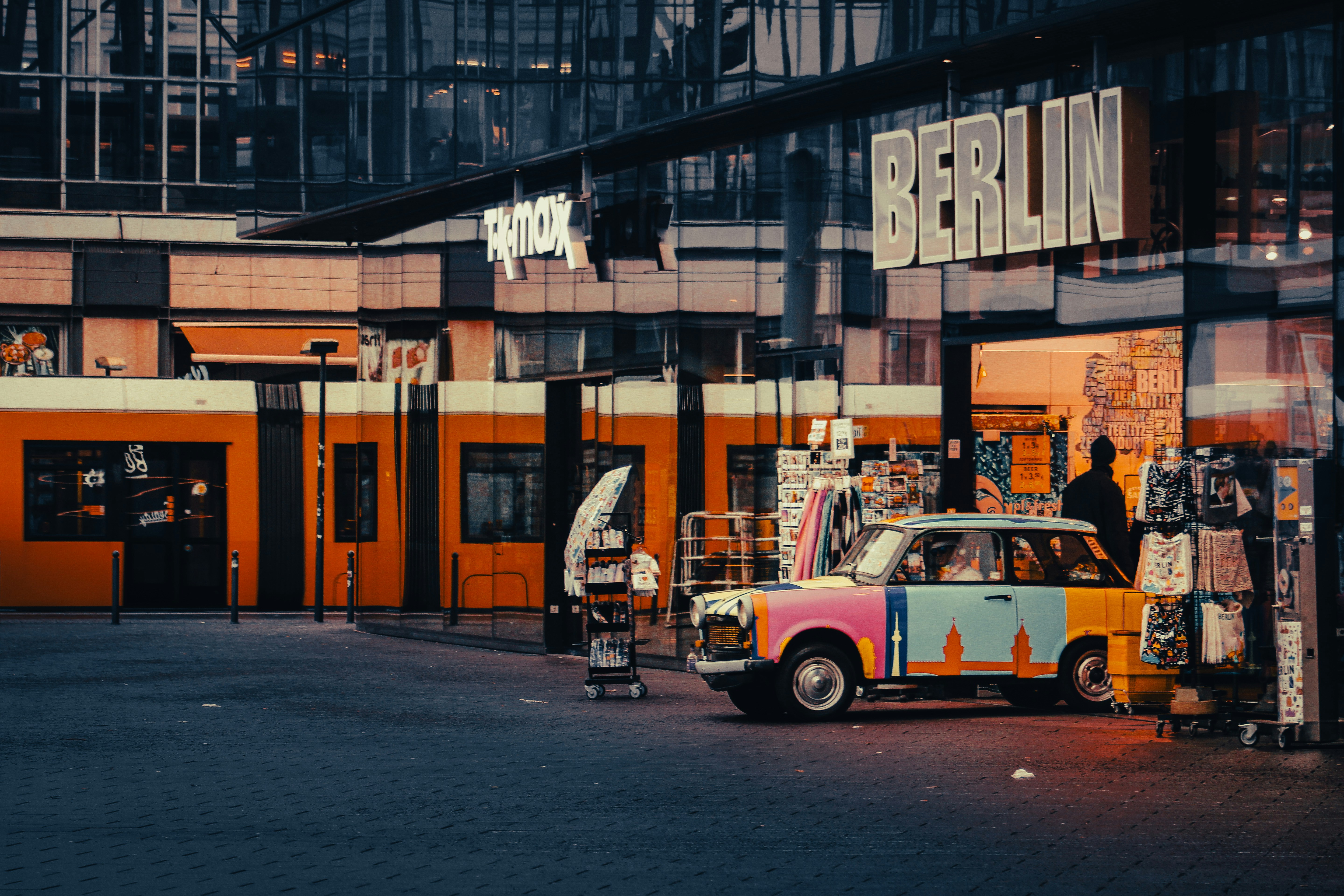 Colorful trabant car parked in front of berlin storefronts