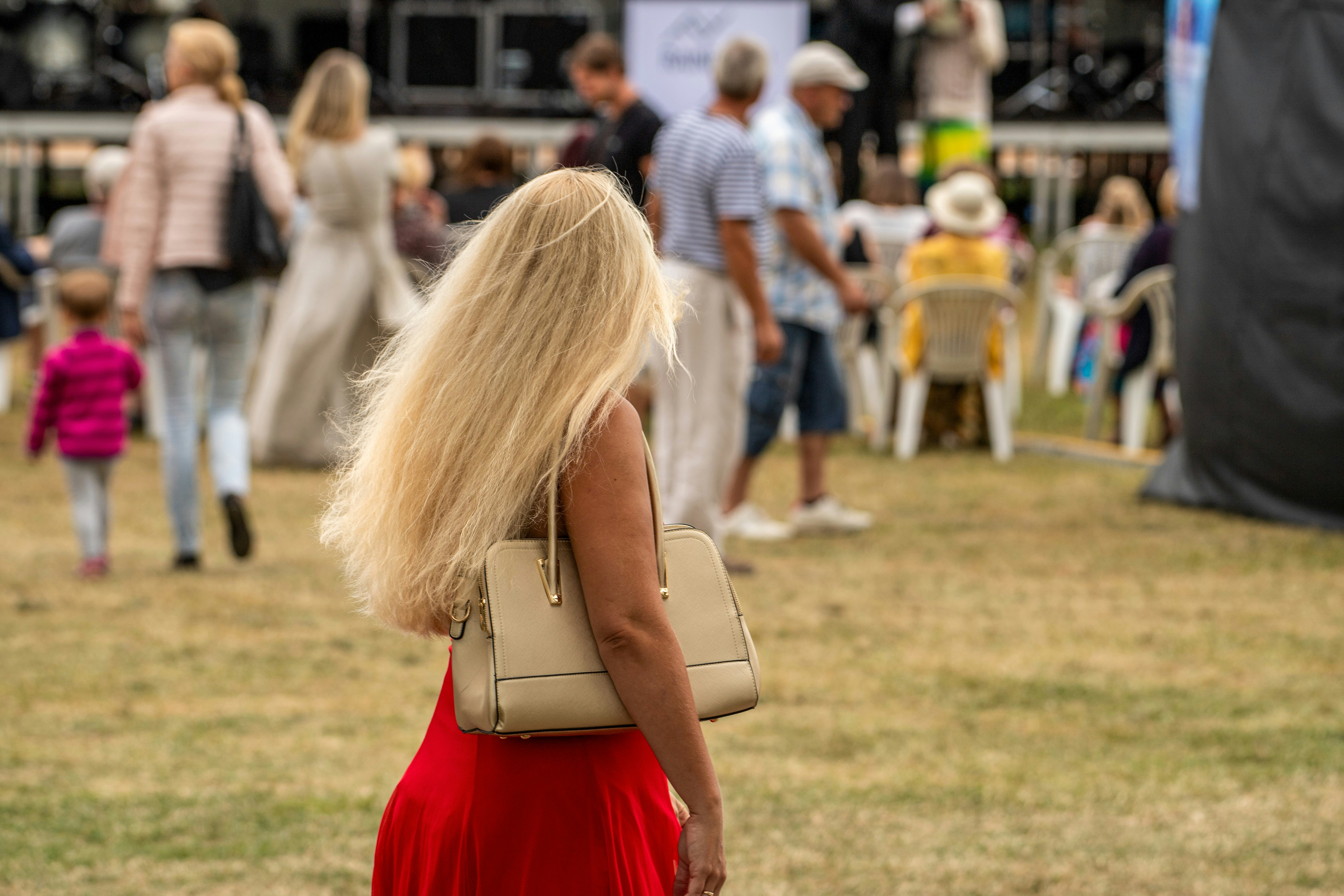 Woman with long blonde hair and red dress