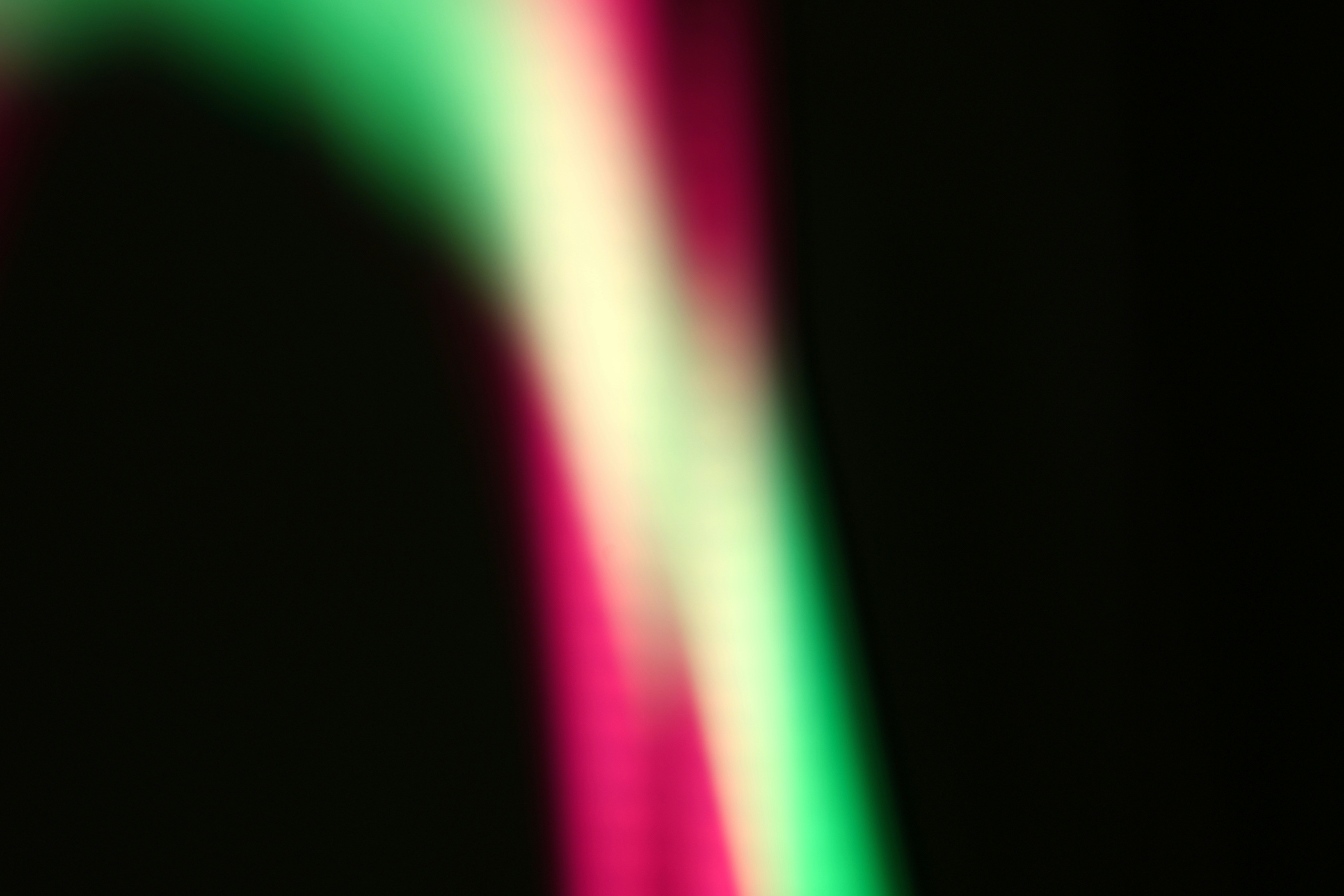 Abstract streaks of pink, yellow, and green light