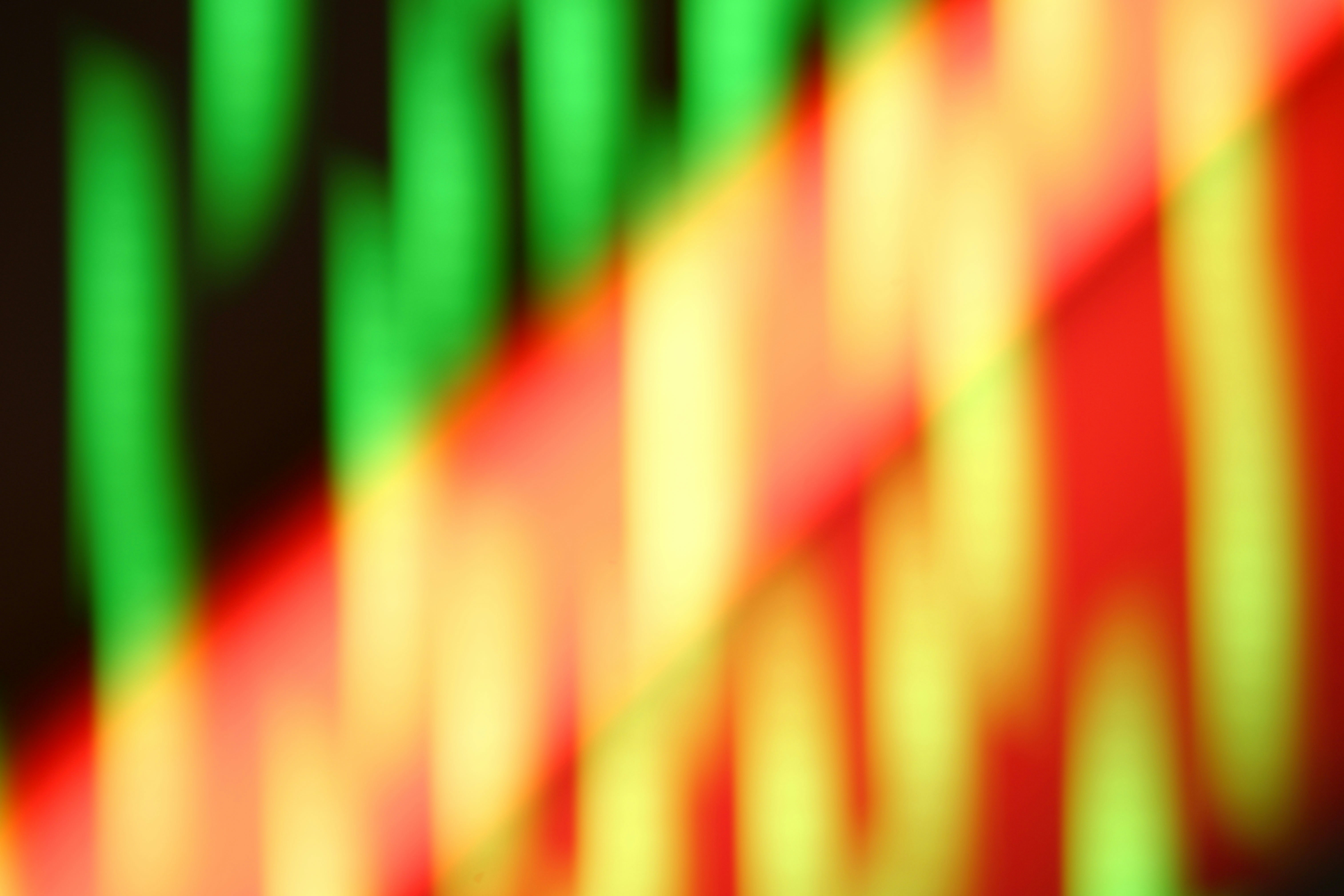 Abstract blur of green and red light streaks.