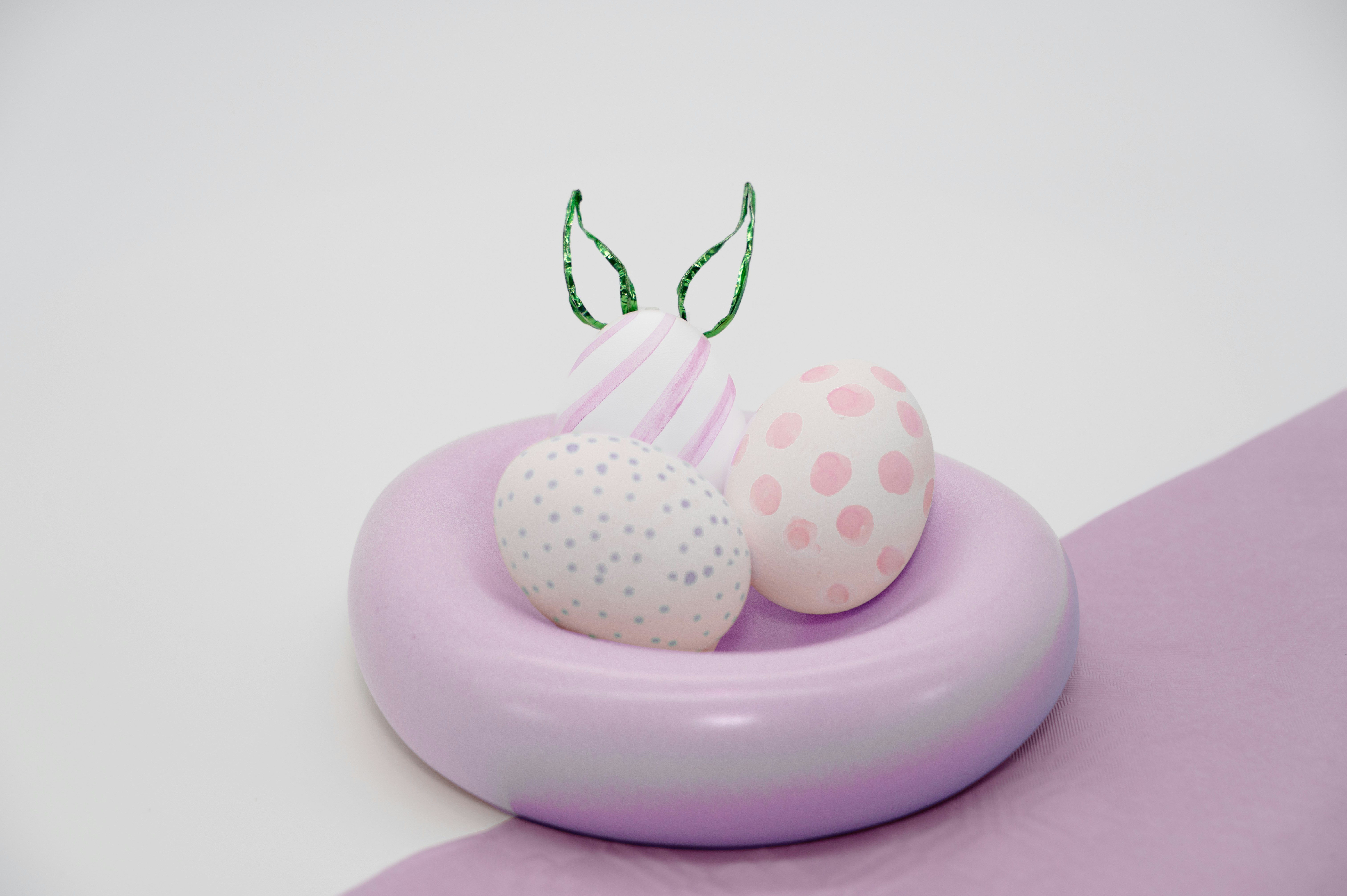Three pastel easter eggs in a nest