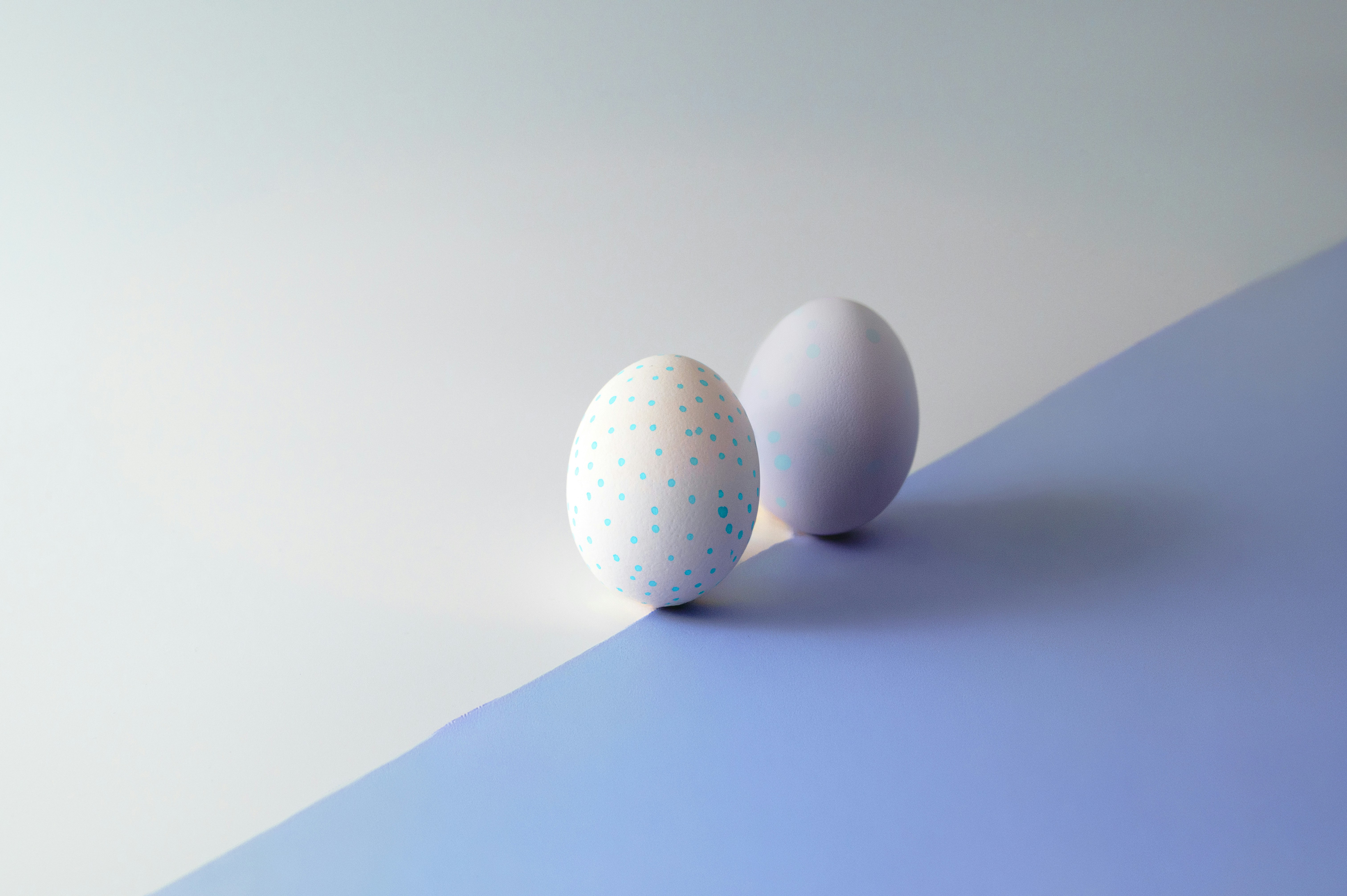 Two eggs on a blue and white surface