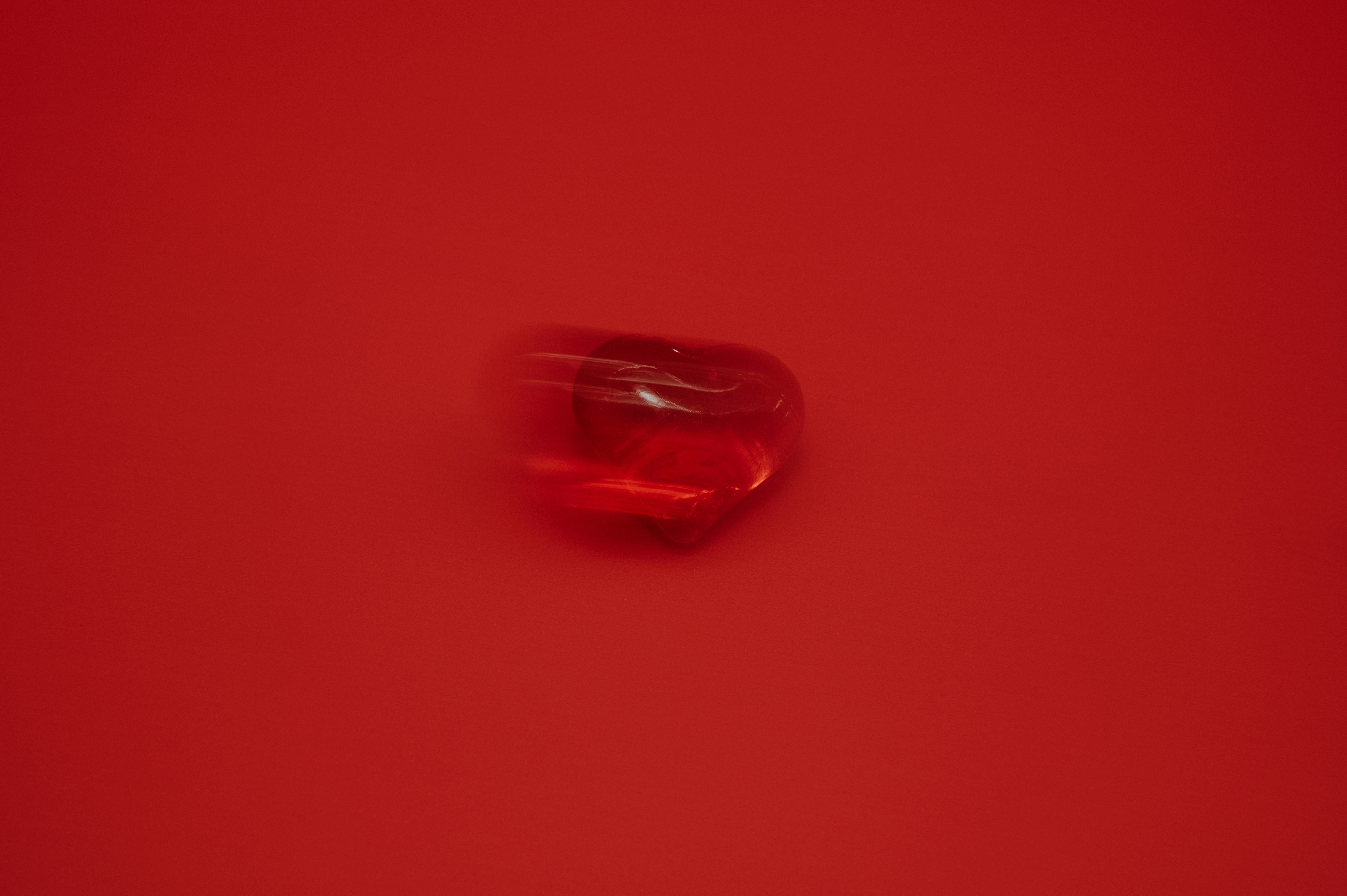 A single red gem on a red background