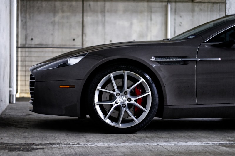 dark grey luxury sedan parked in premium garage