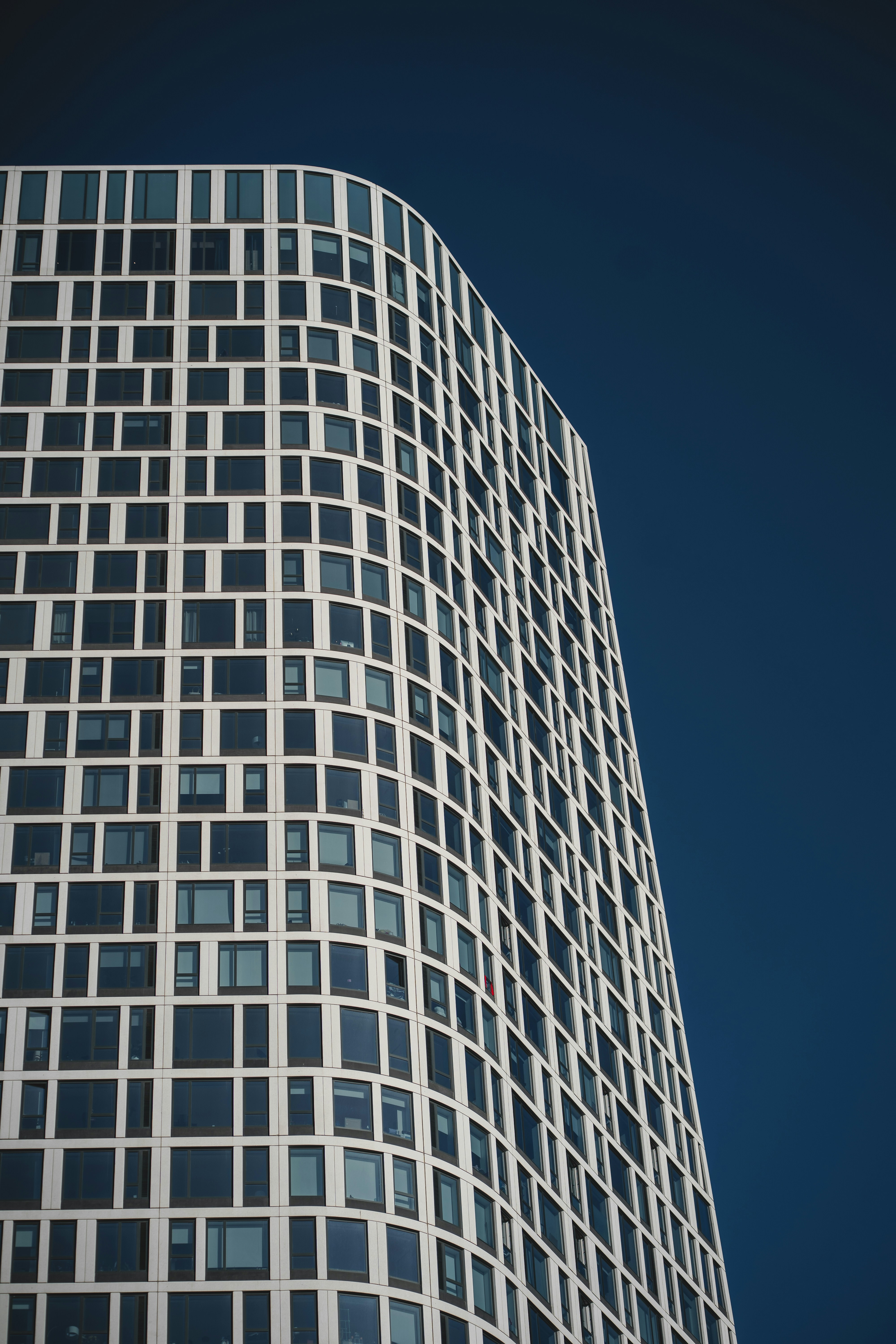 Modern skyscraper with a geometric facade against blue sky