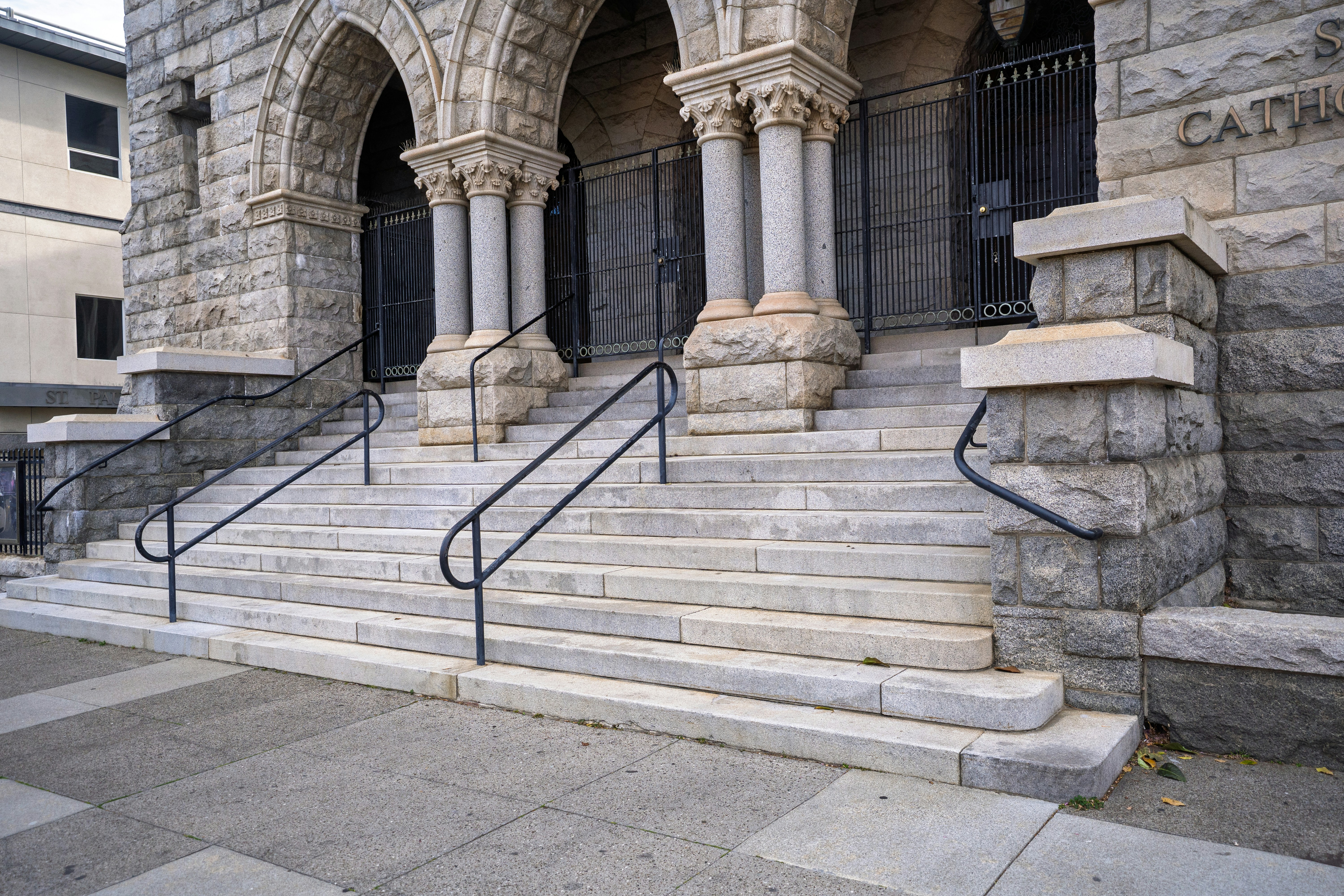 Stone steps lead up to arched doorways of a building.