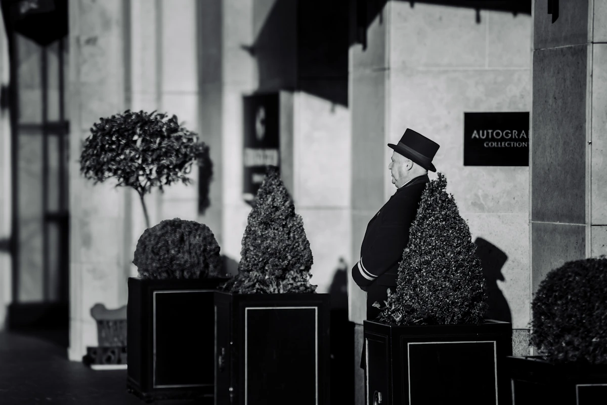 Uniformed luxury hotel doorman, representing ARK People Solutions brand experience consulting in Dubai