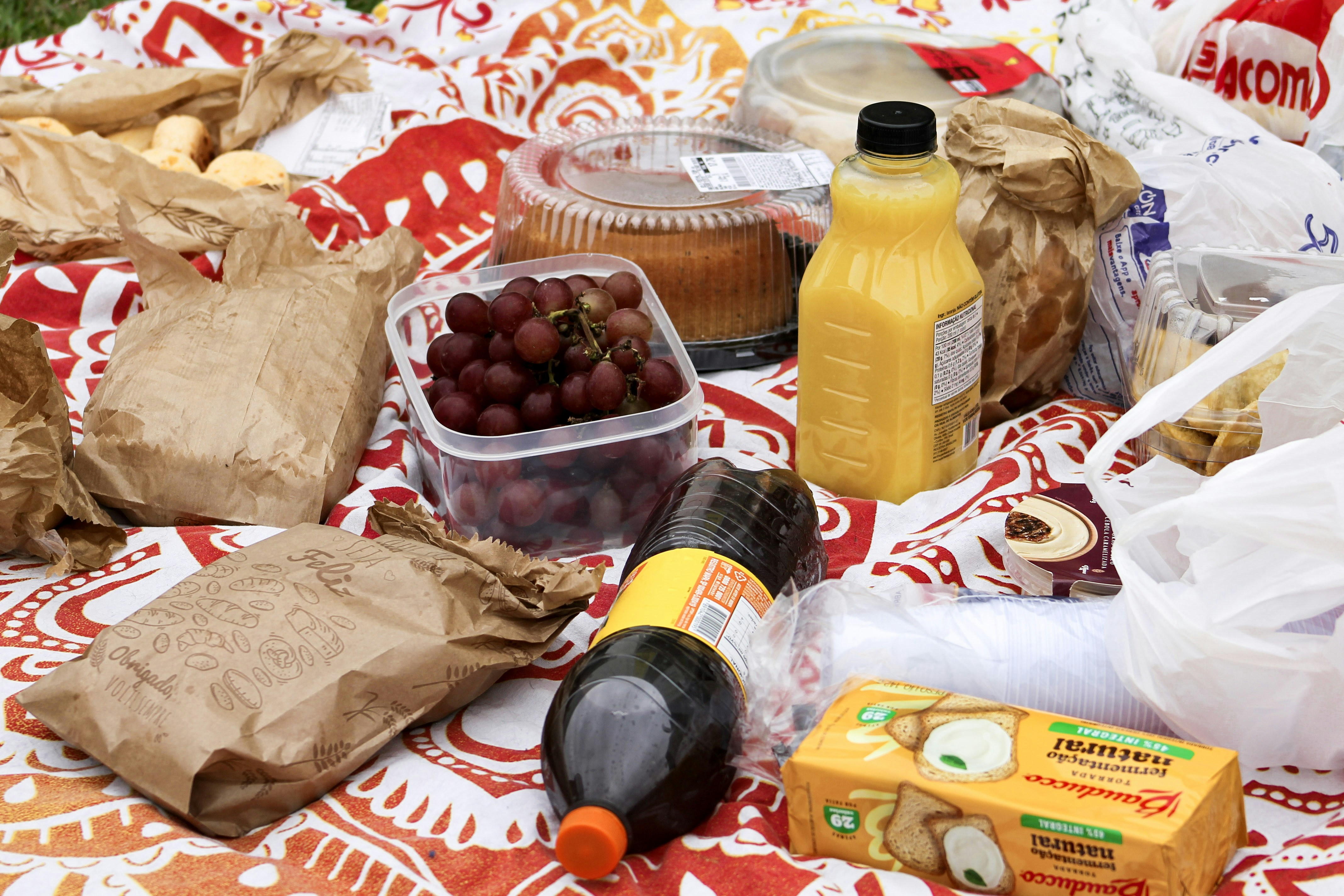 Picnic spread with food and drinks on a blanket