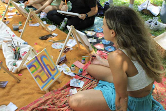 People painting outdoors at an art class