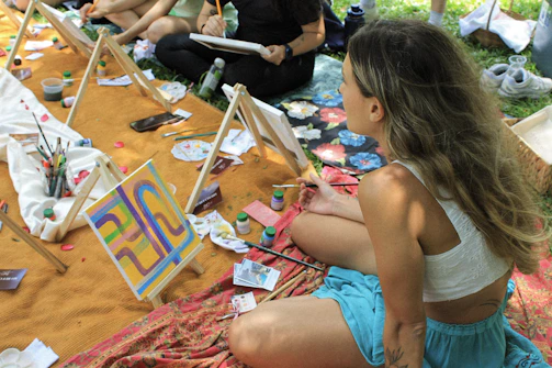 People painting outdoors at an art class.