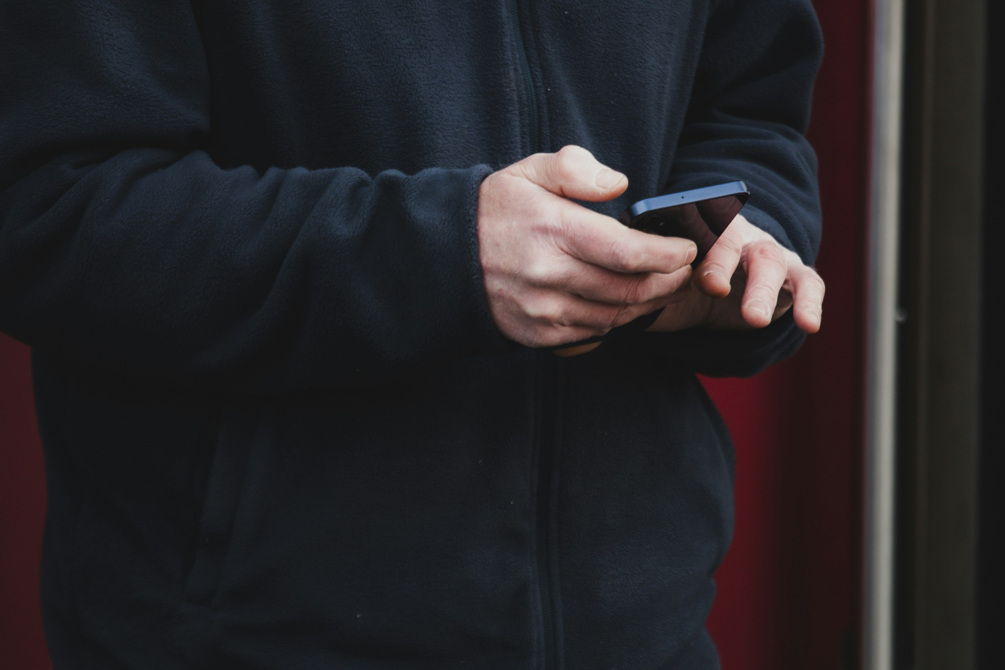 Person's hands holding a smartphone