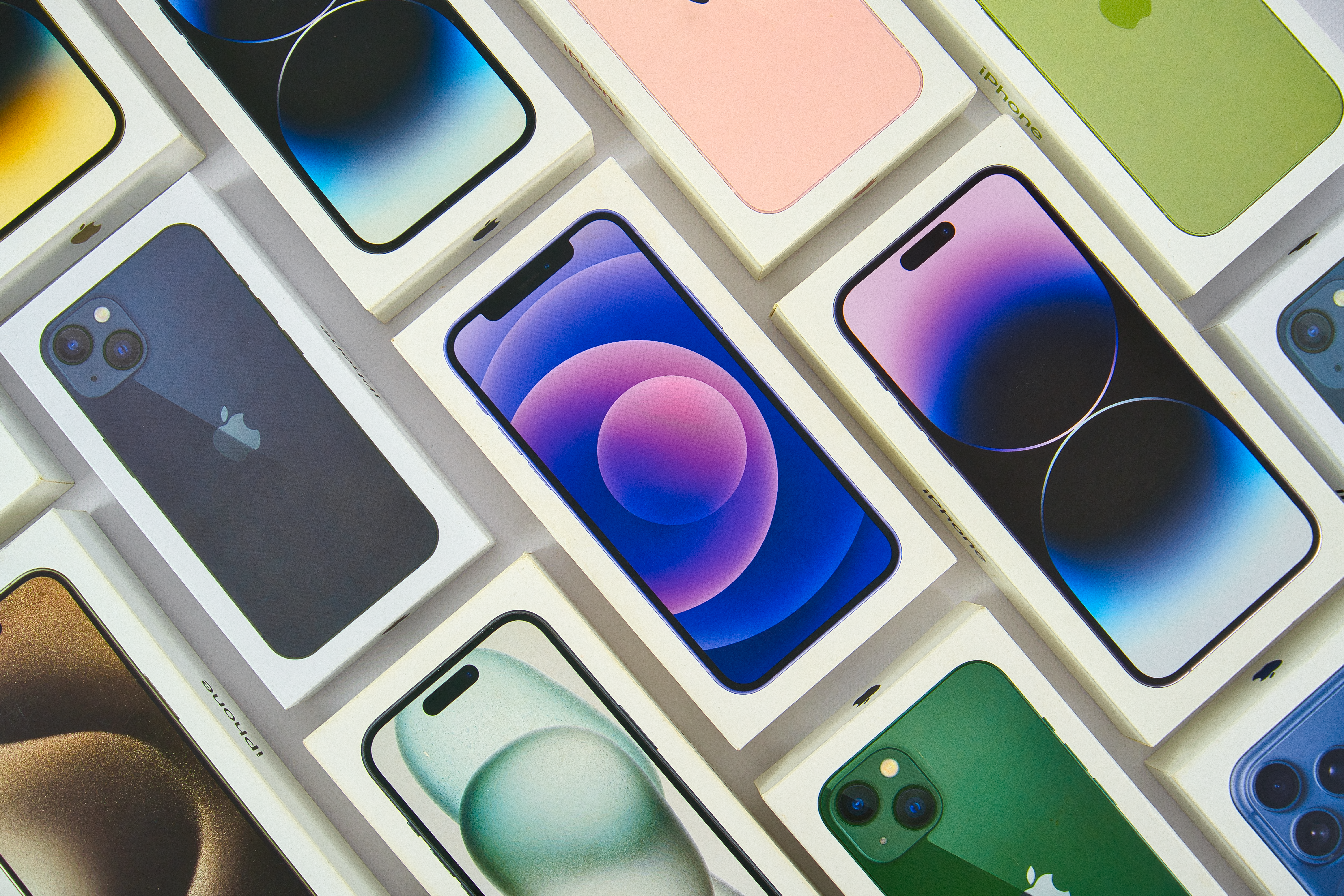 Multiple iphones displayed in their boxes