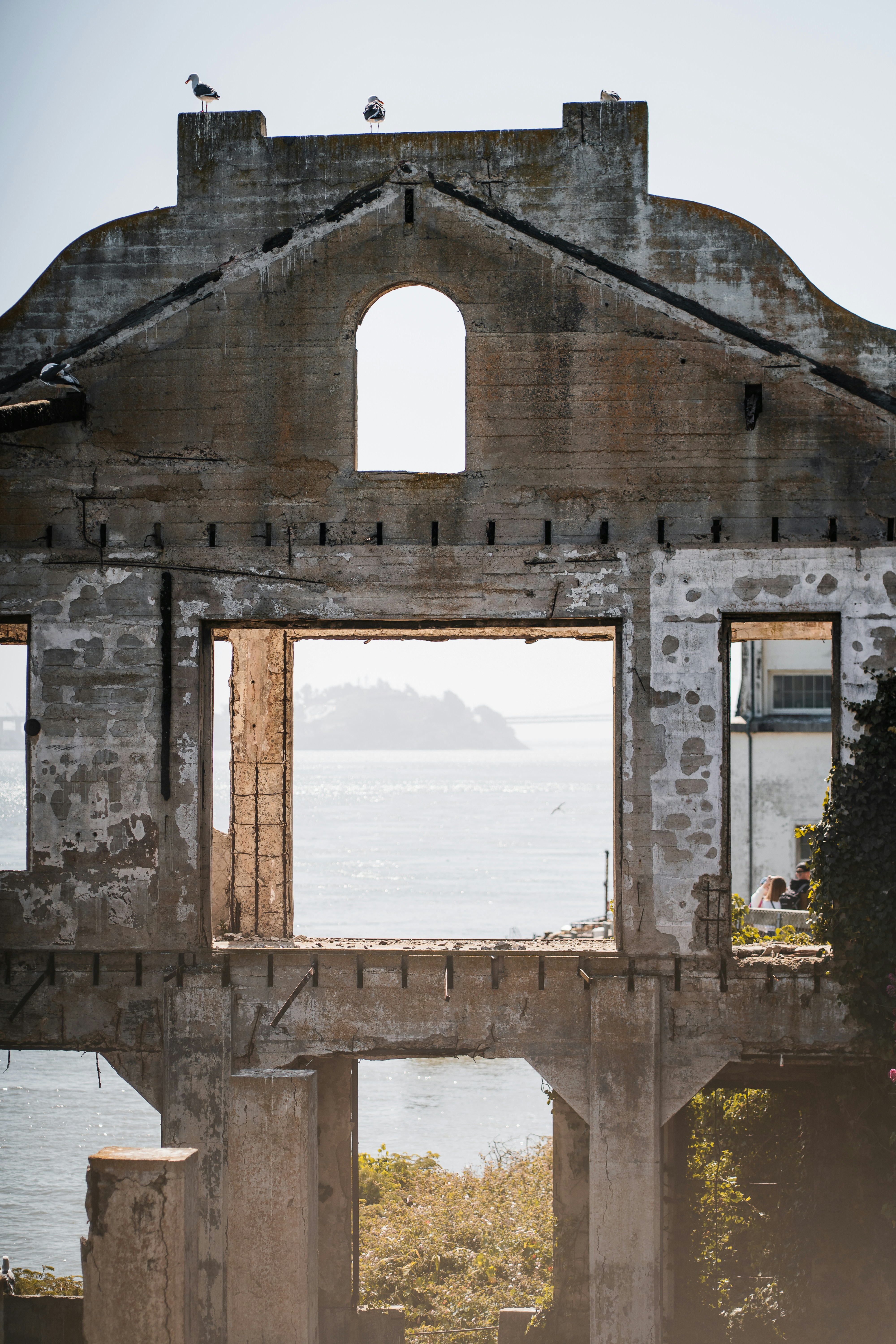 Edificio in cemento in rovina con vista sull'oceano e gabbiani