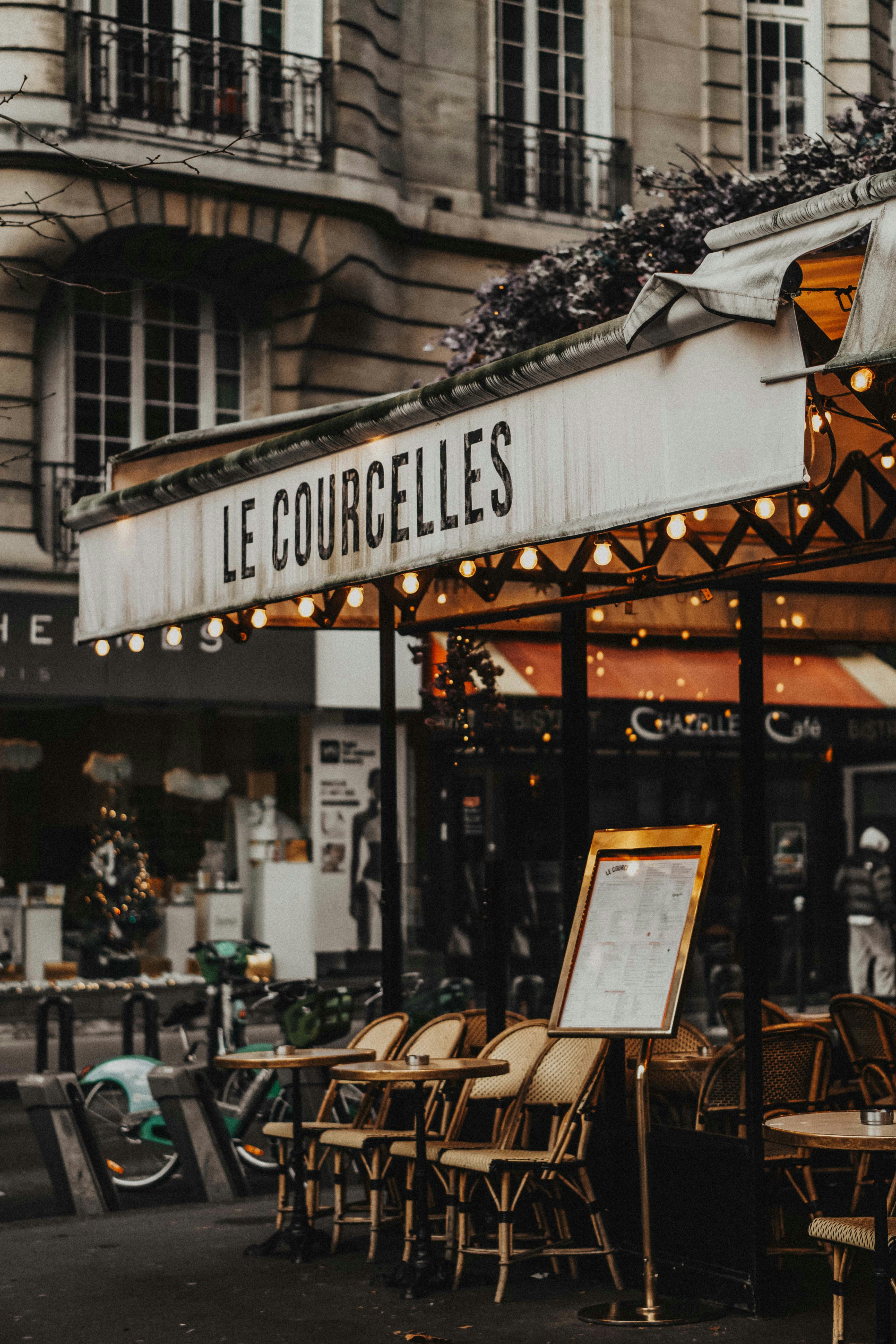 Outdoor cafe seating in front of a parisian building
