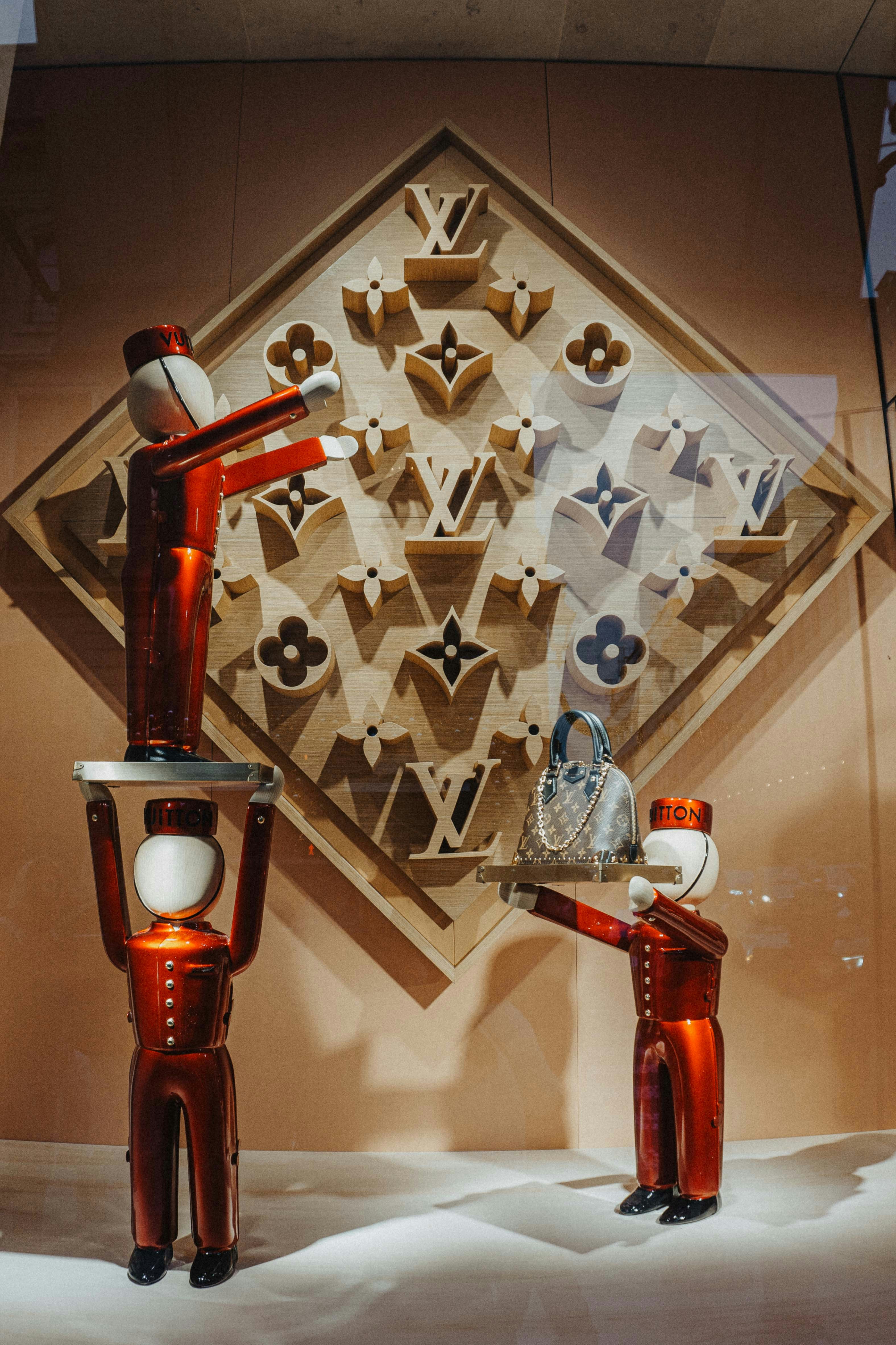 Red figures display louis vuitton logos and handbag