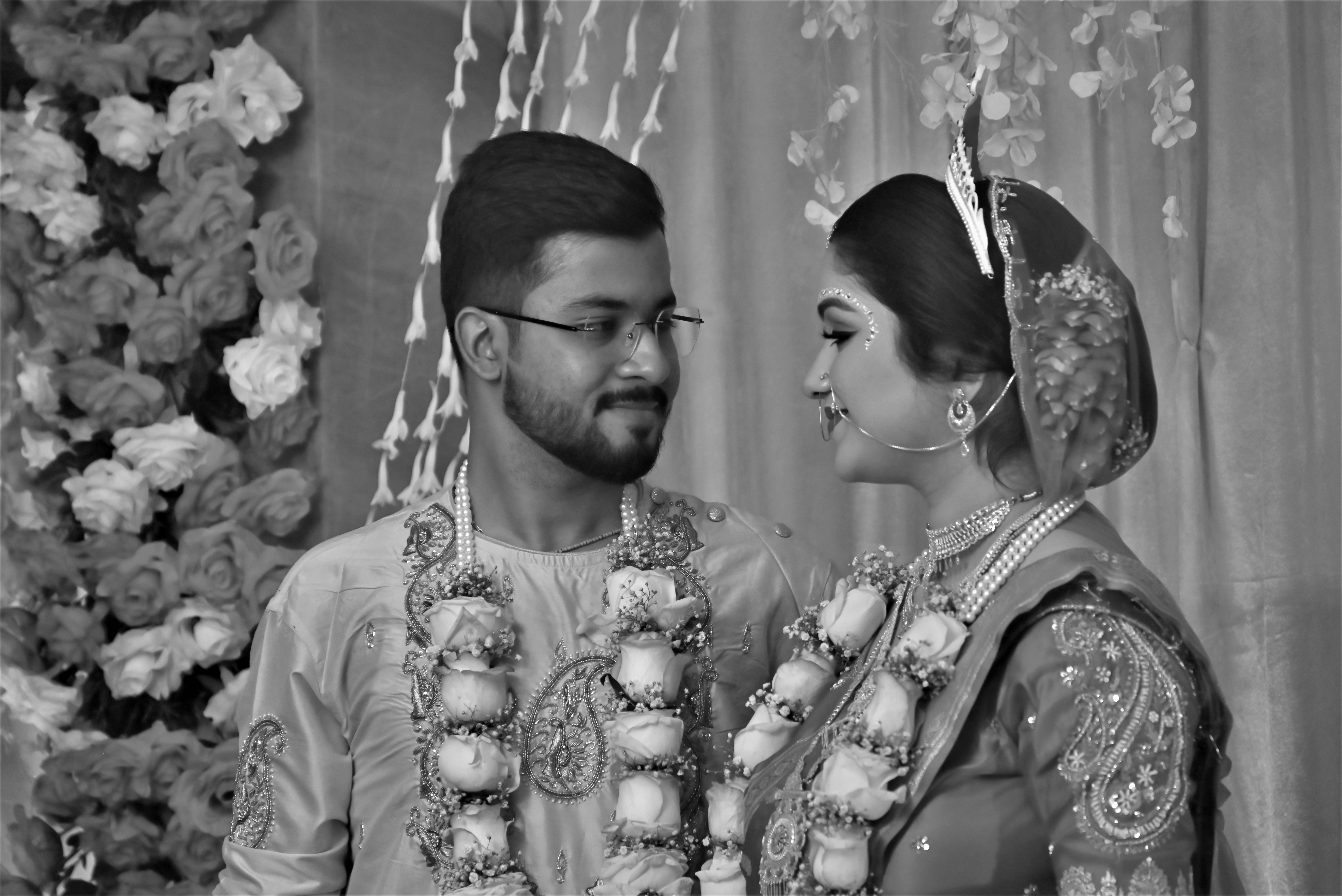 A couple in traditional attire looking at each other