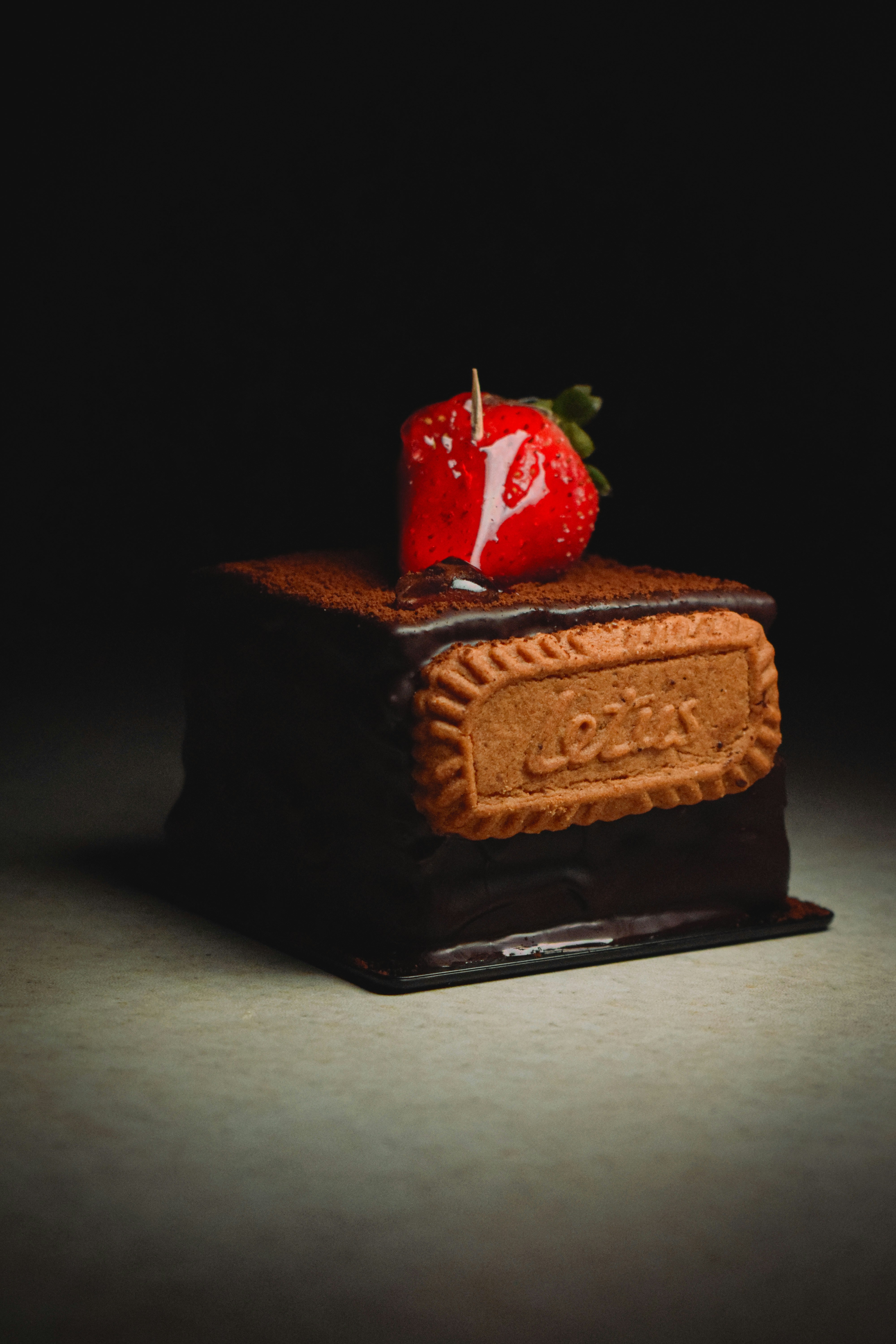 Chocolate cake with strawberry and biscuit topping